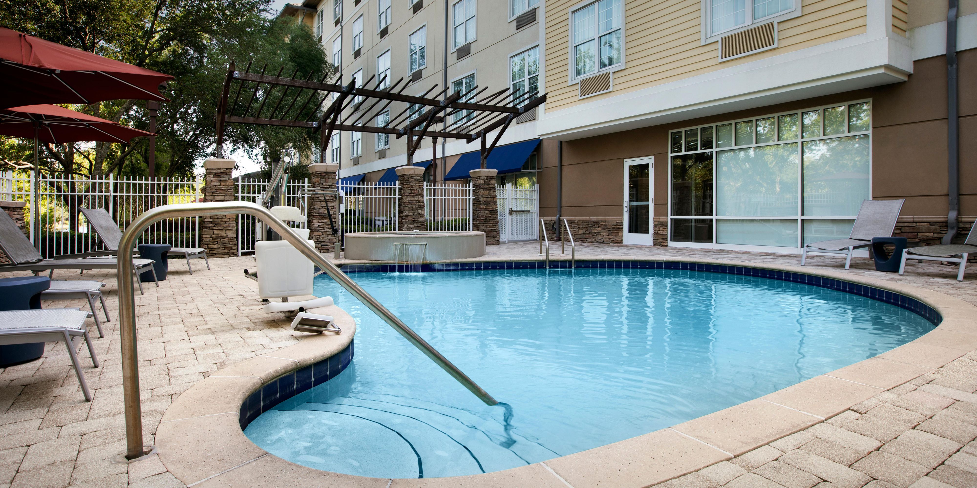 Sun-soaked pool at Hotel Indigo Jacksonville Deerwood Park FL.