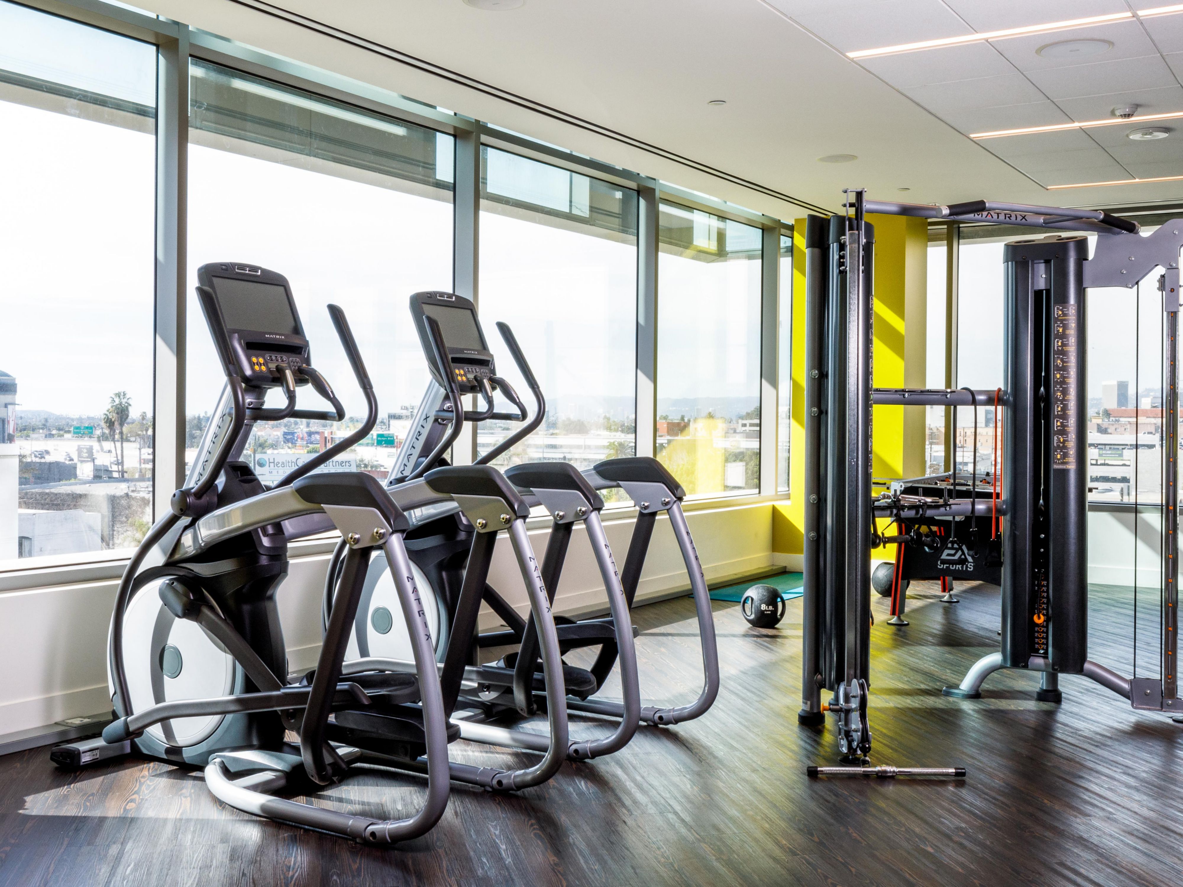 On-site fitness center with elipticals and machines that overlook downtown Los Angeles