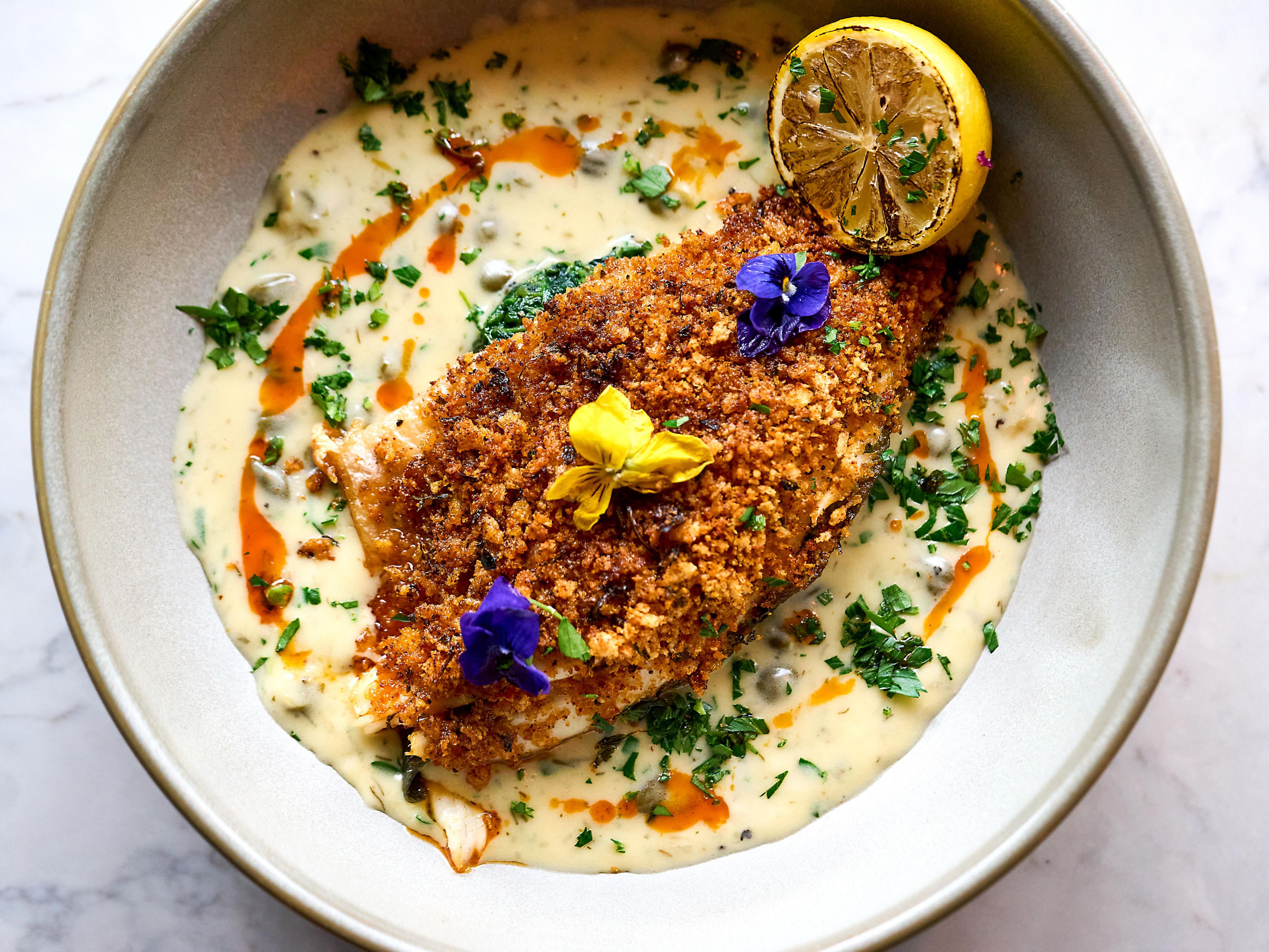 Grilled sea bass with a spicy nduja crumb and wine sauce