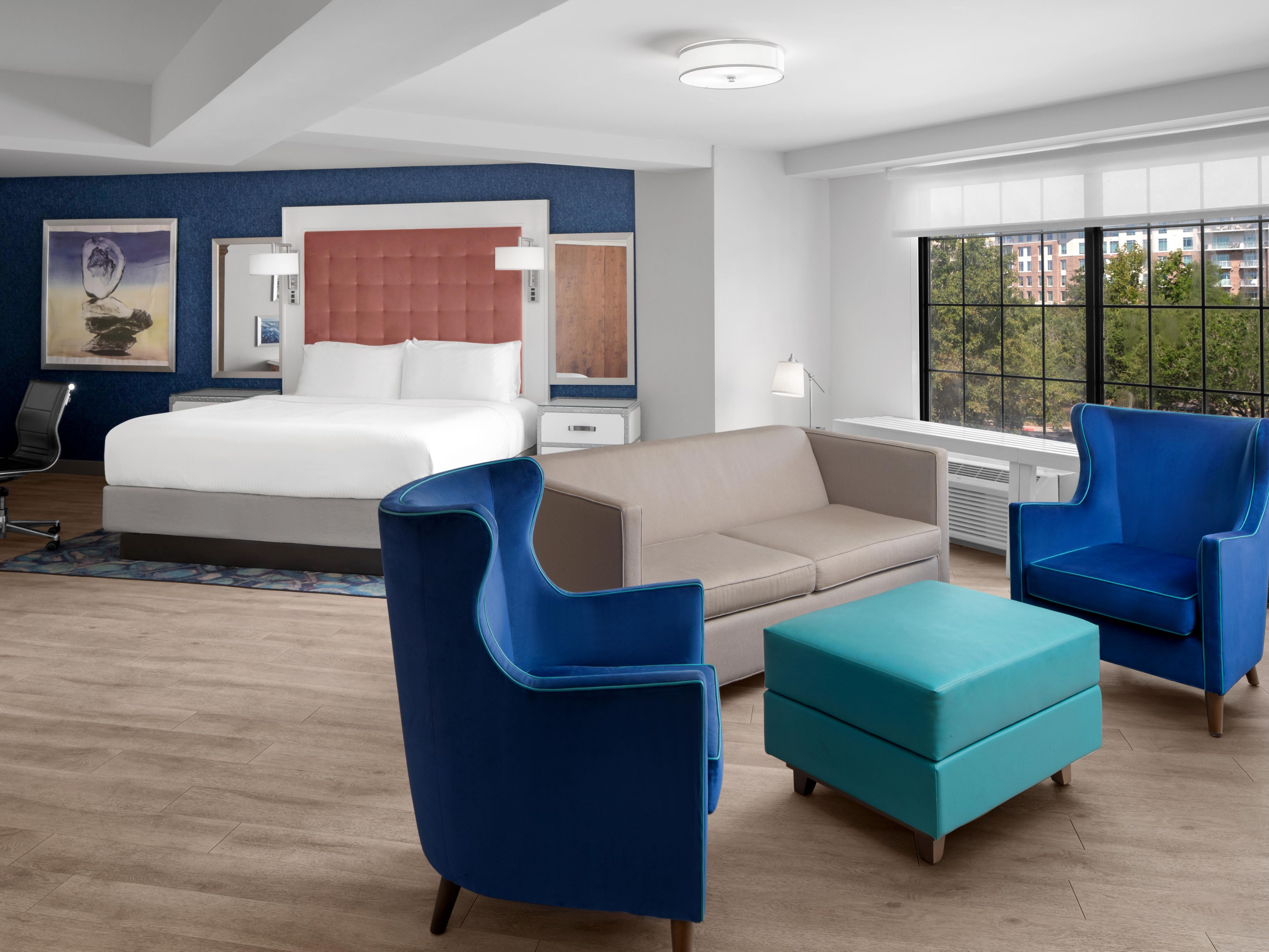 Lounge in a sunlit king suite made for stylish Charleston stays.