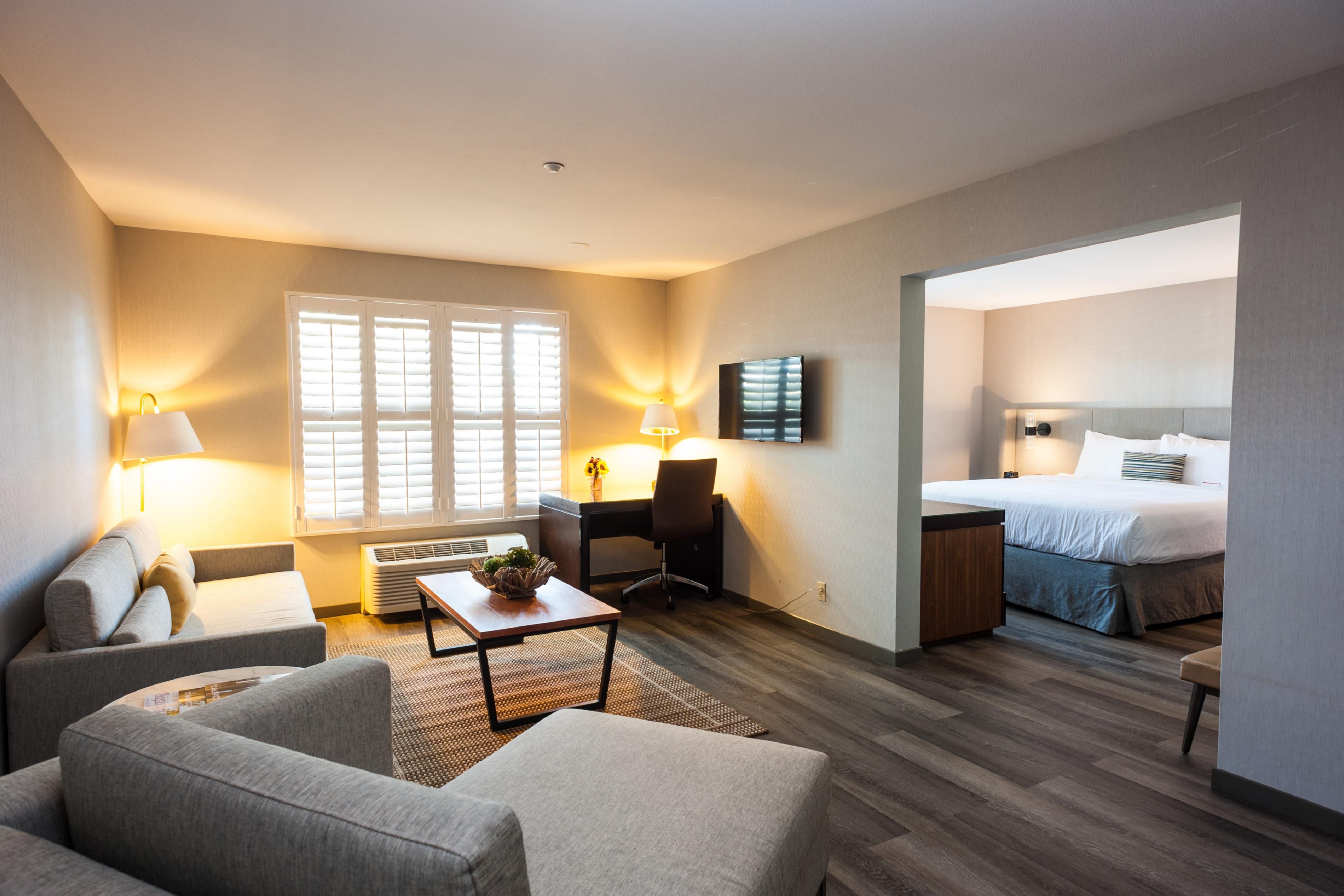 Our guest rooms are a home away from home, boasting plush beds, a lounge area, hardwood floors, and plantation shutters, all designed for tranquil relaxation. For added convenience, our rooms include refrigerators, Keurig coffee makers, and in-room safes, ensuring a seamless stay in Napa Valley. 