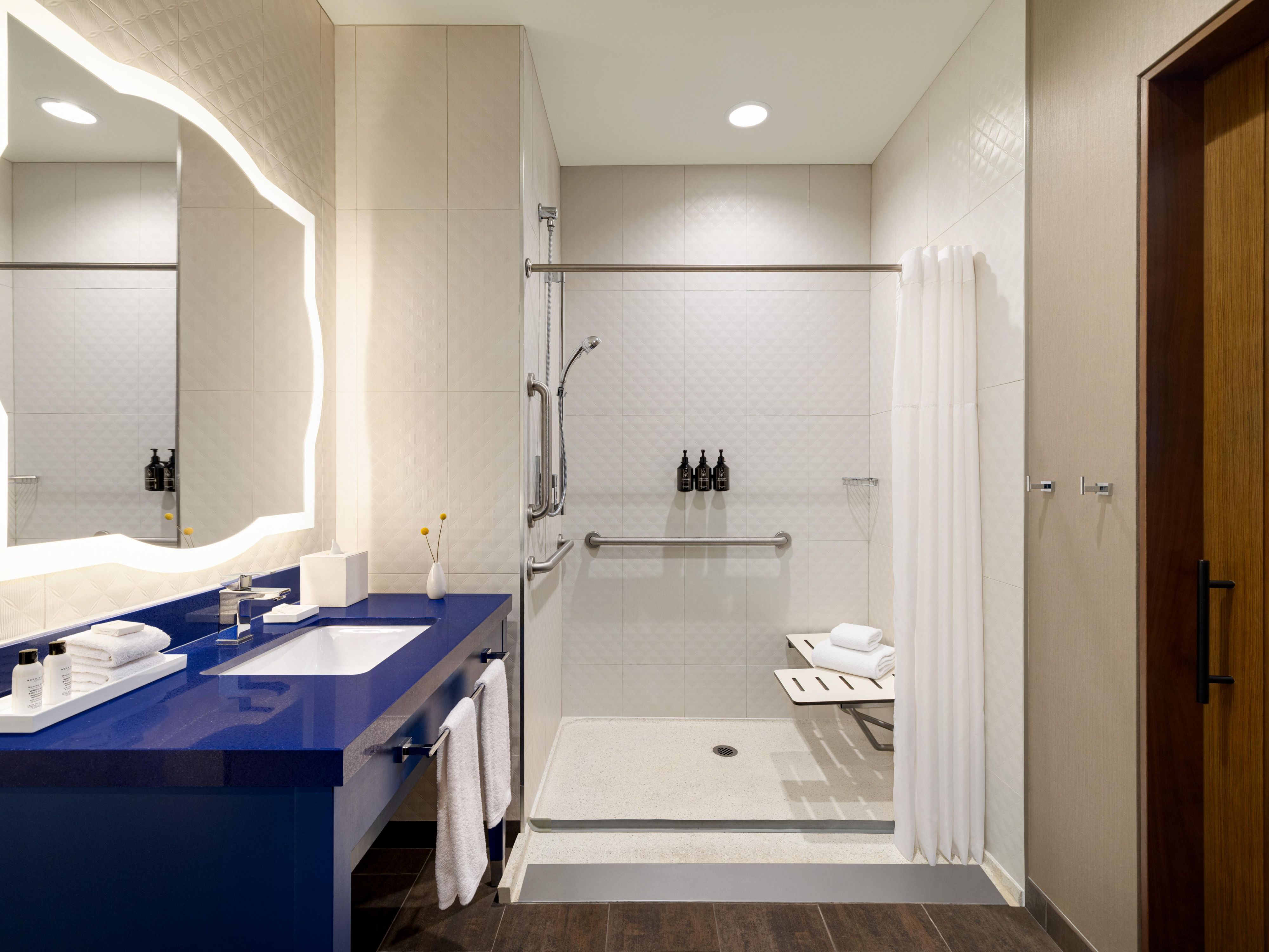 Our Deluxe bathrooms feature a luxurious rain head shower.