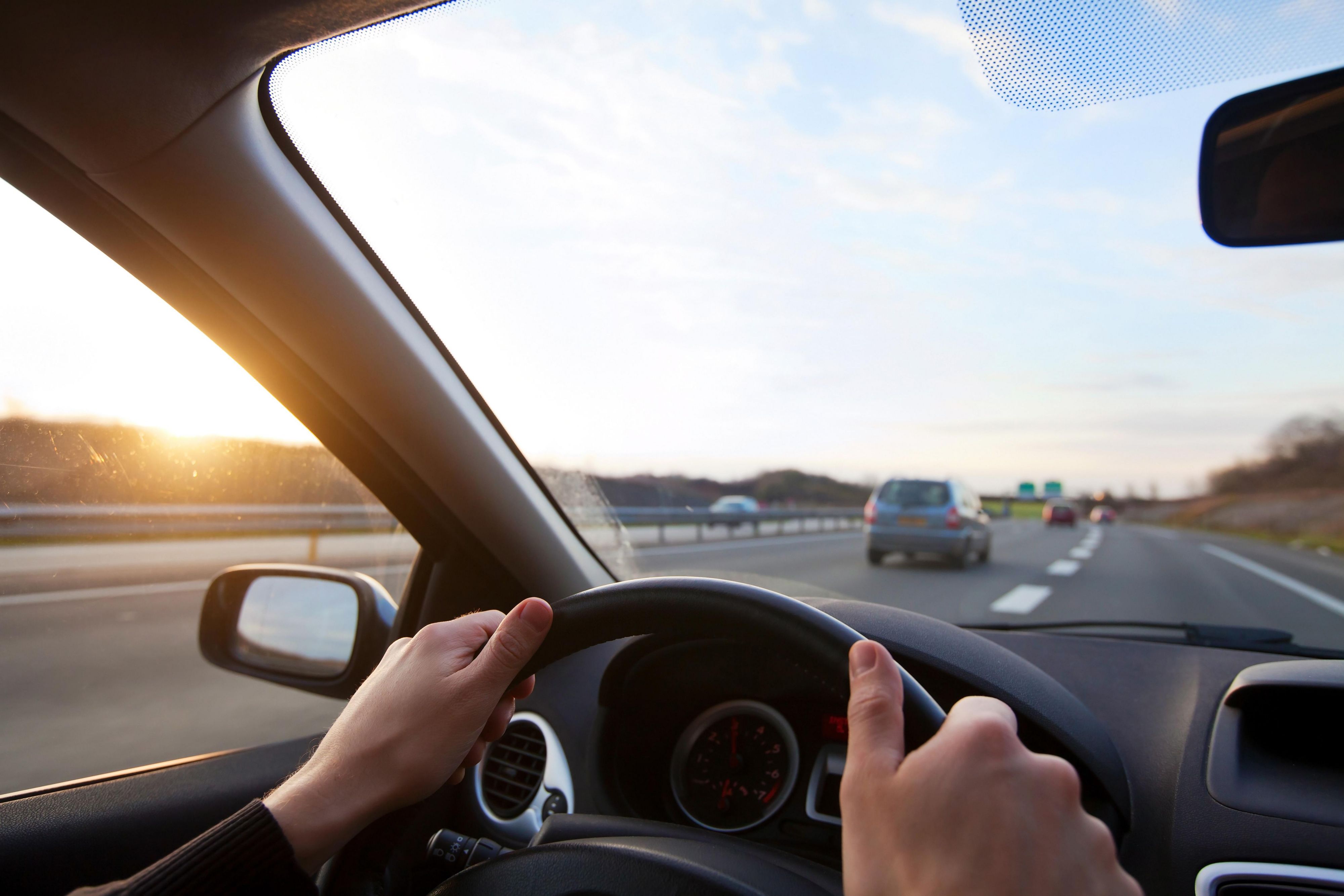 man steering a car