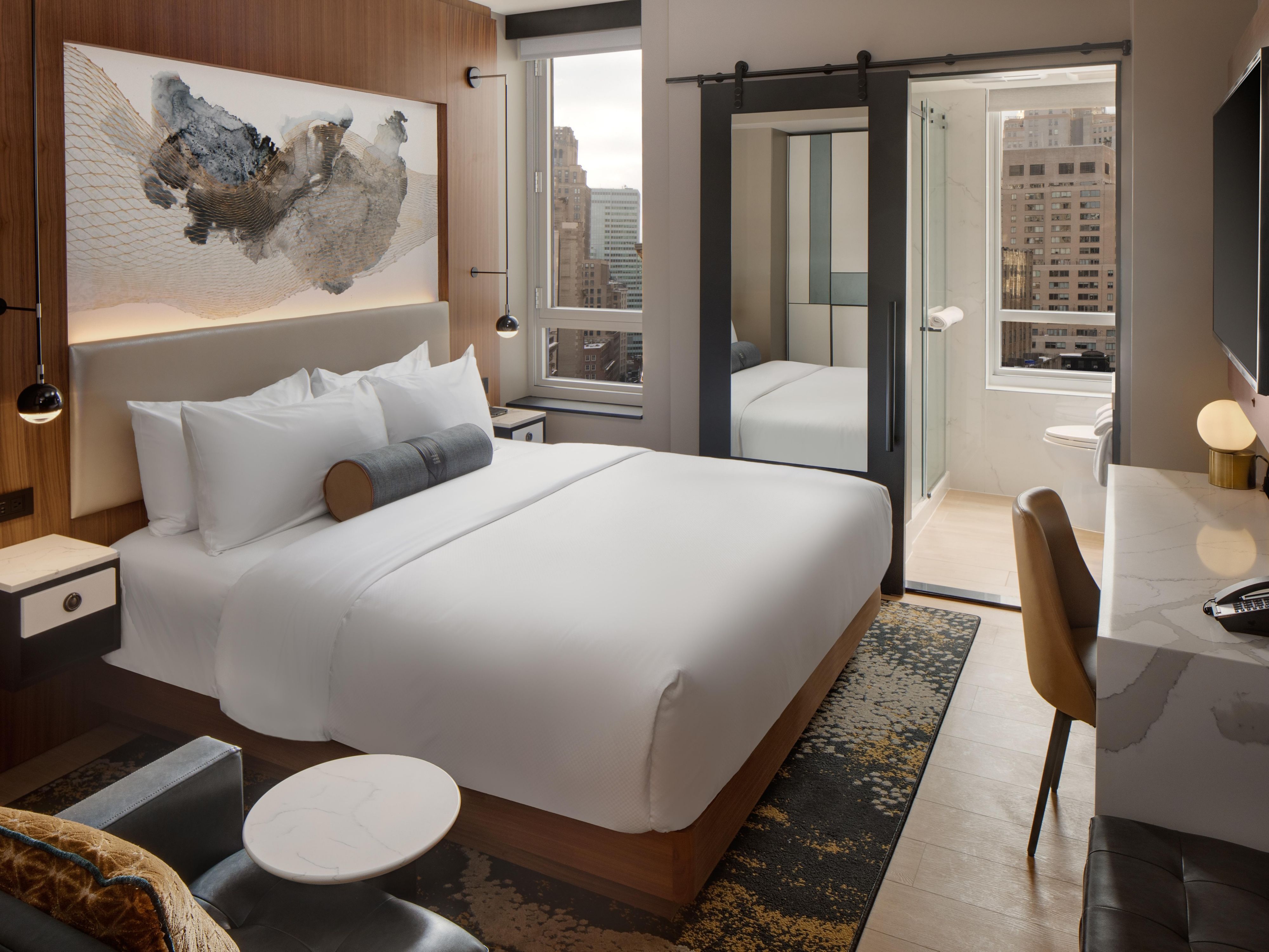 Step into tranquility and sophistication at our Wall Street boutique hotel, featuring hardwood floors, modern decor, and noise-canceling, double-insulated windows. Stay connected with free Wi-Fi and entertained with a selection of HD channels or connect your own device through IHG Studio. Upgrade to a room with a balcony for stunning city views.