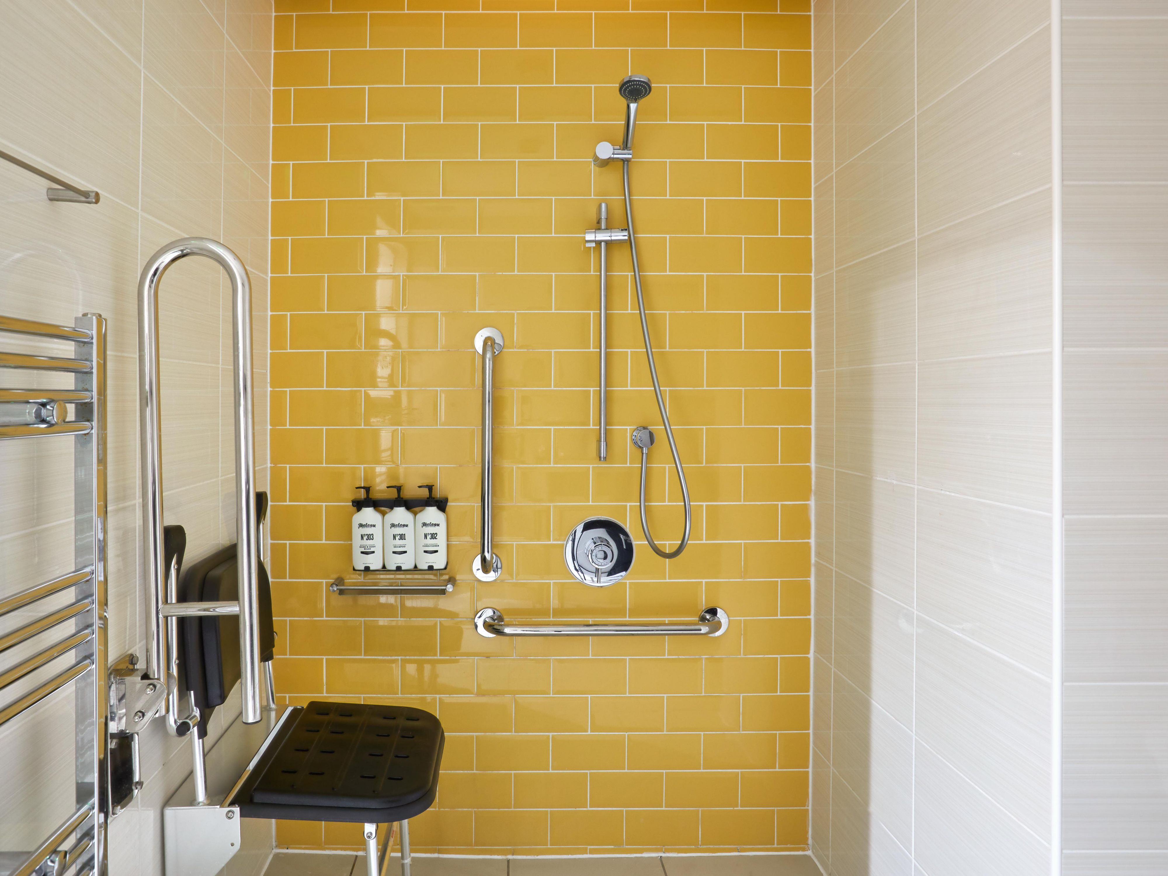 Refurbished Accessible Bathroom with Shower Chair and Handrails