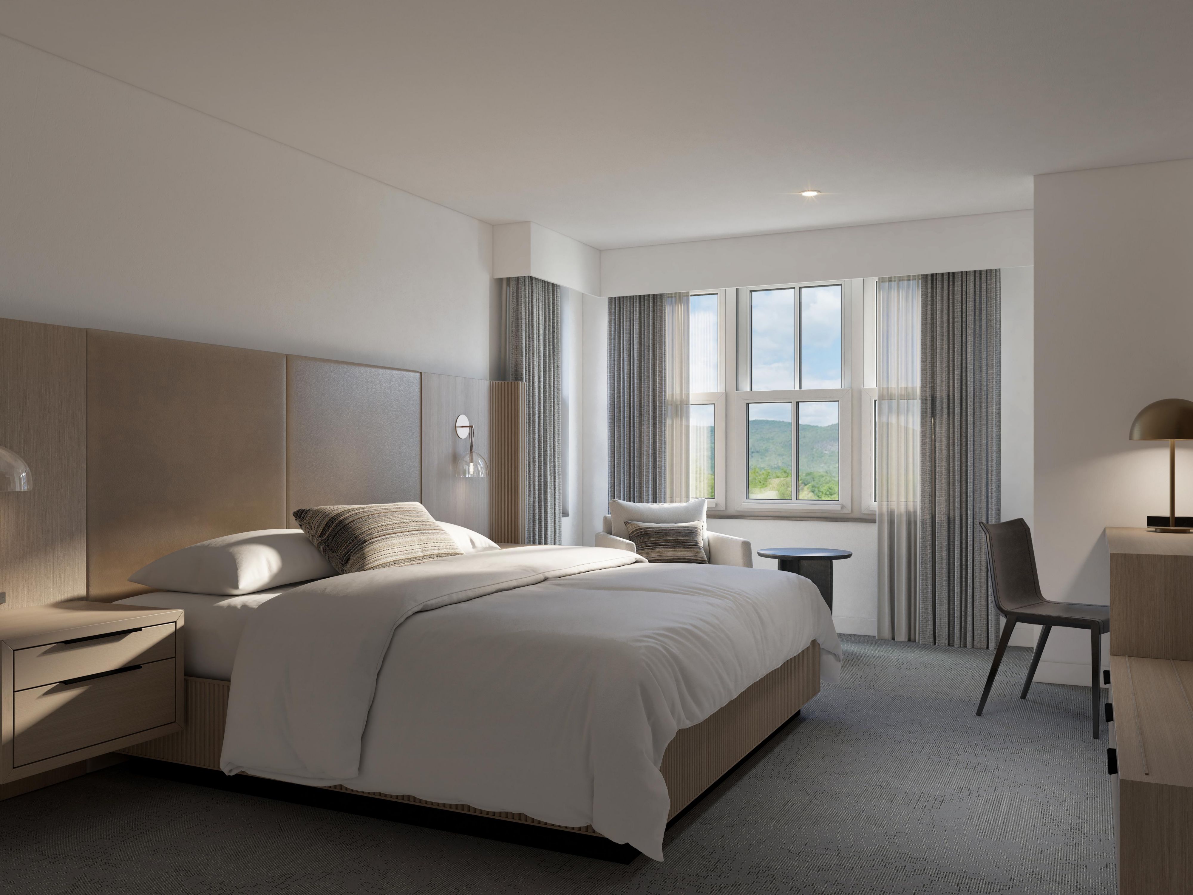 A cozy king bedroom available at Hotel Indigo North Conway.