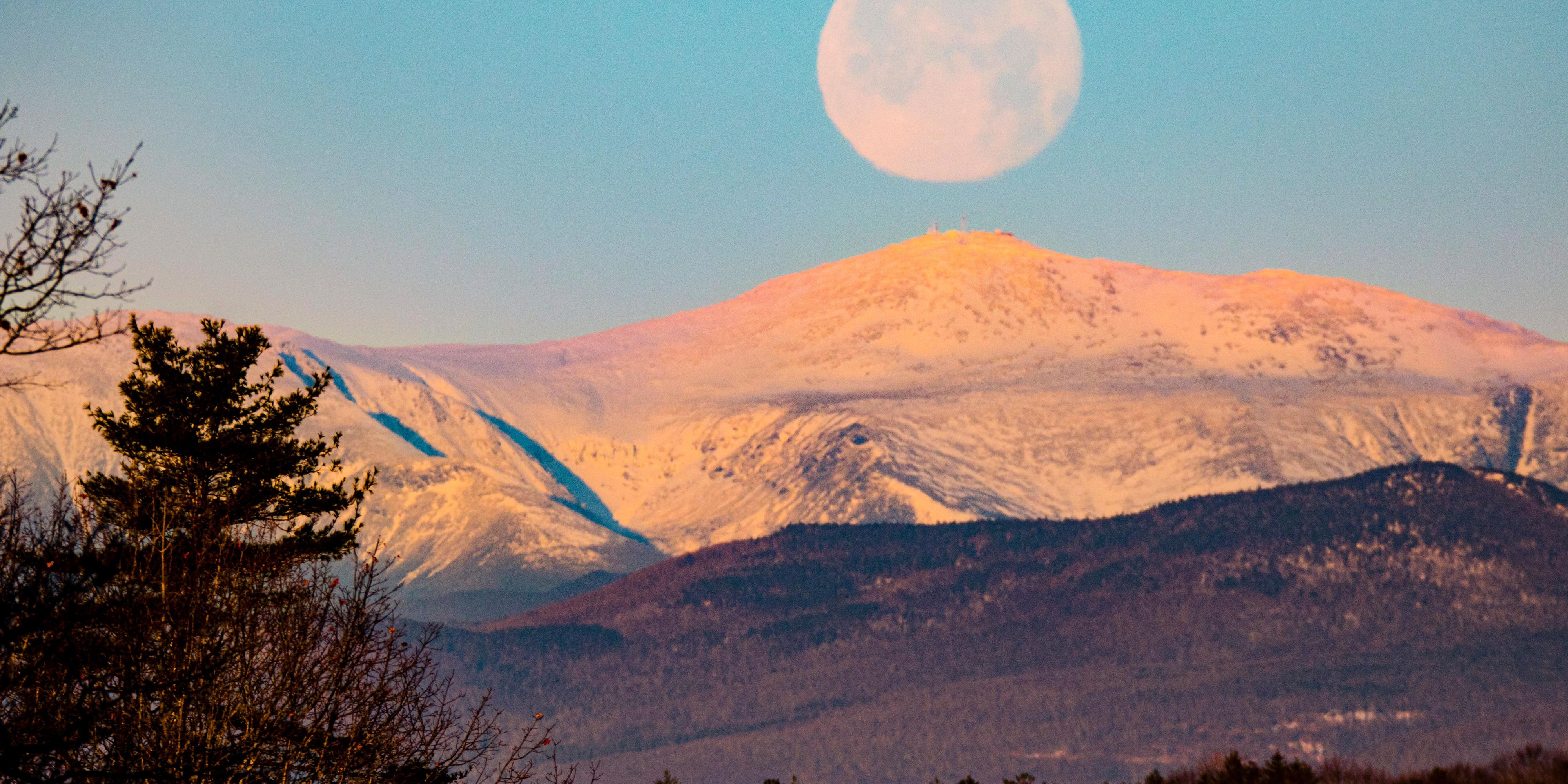 Moonrise over the White Mountains paints the peaks.