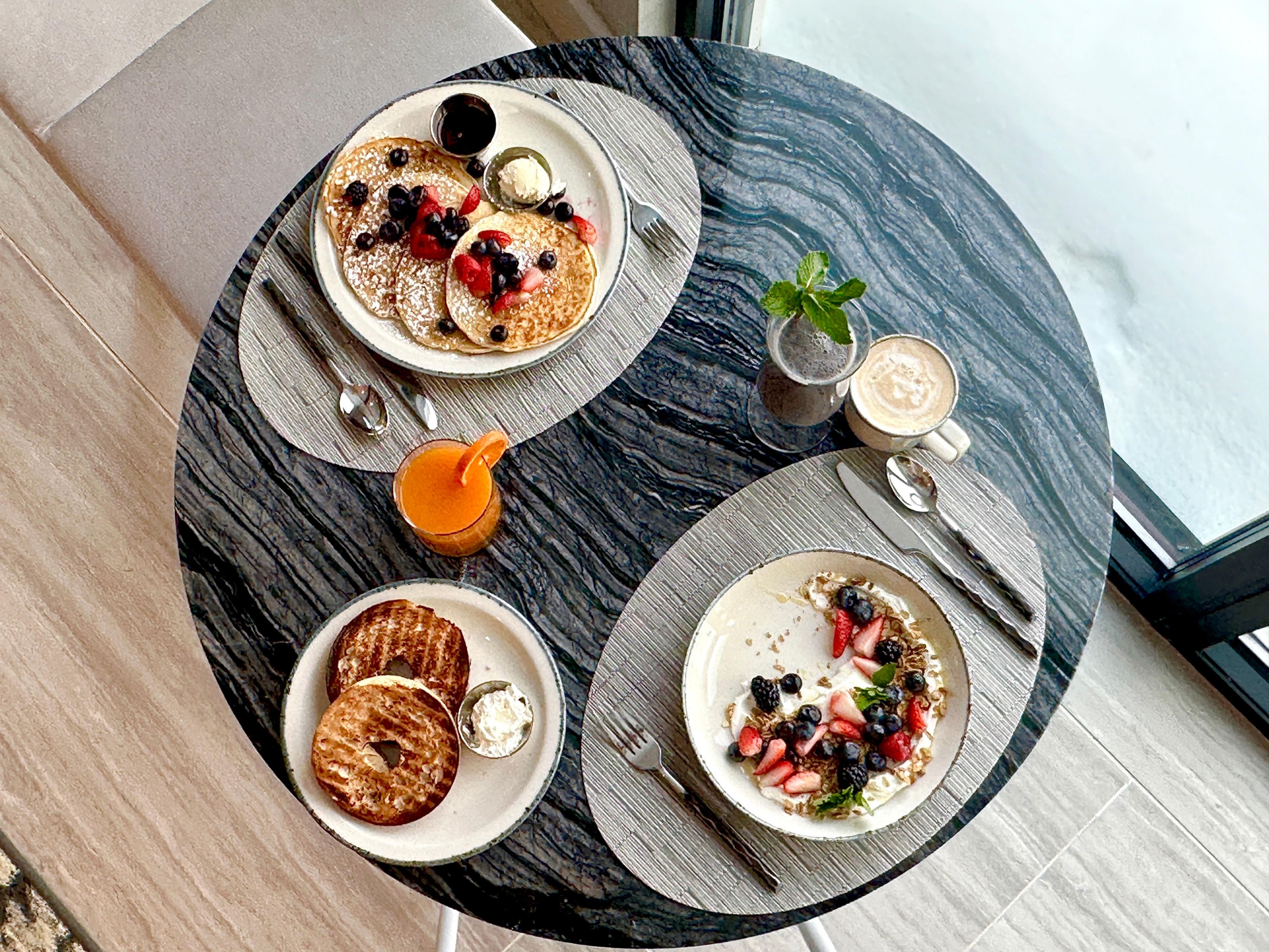 Breakfast for two, yogurt and berries paired with fluffy pancakes