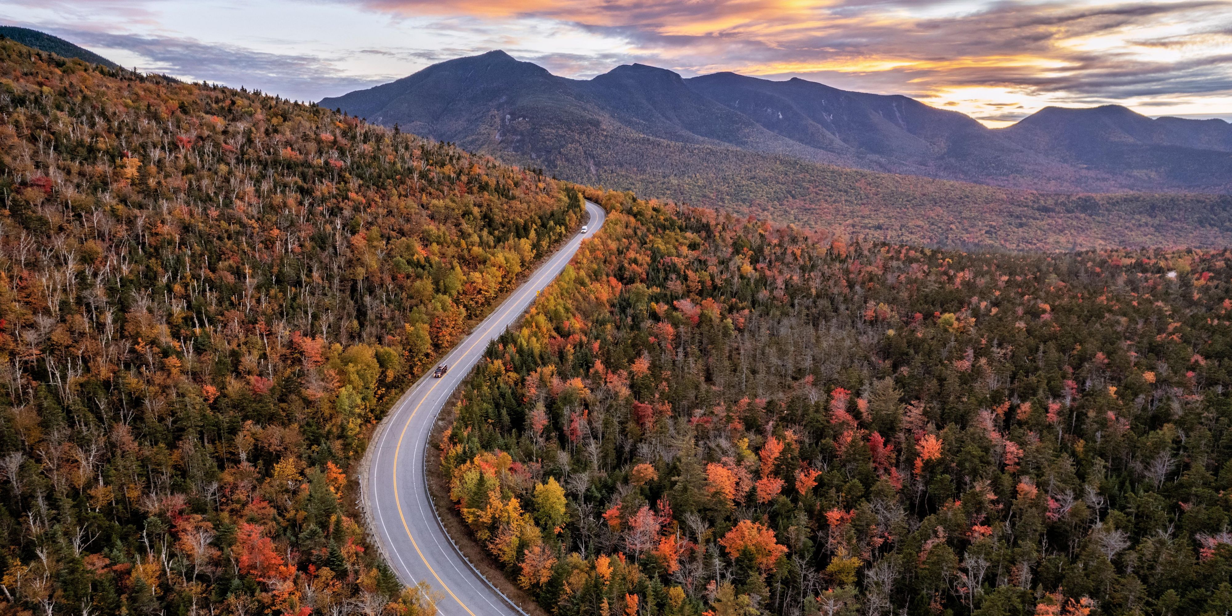 Kancamagus Highway glowing with fall foliage in White Mountains.