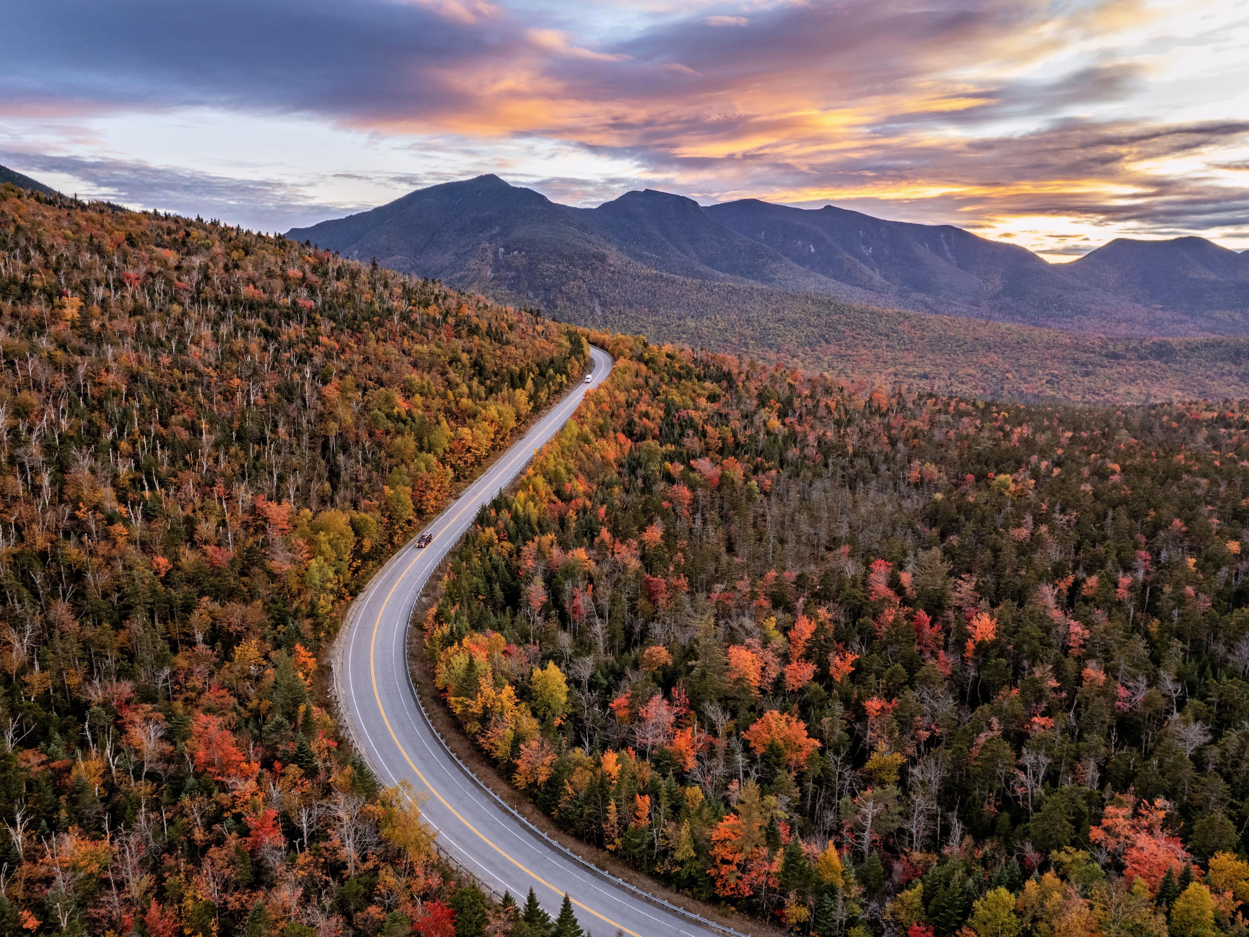 Kancamagus Highway glowing with fall foliage in White Mountains.