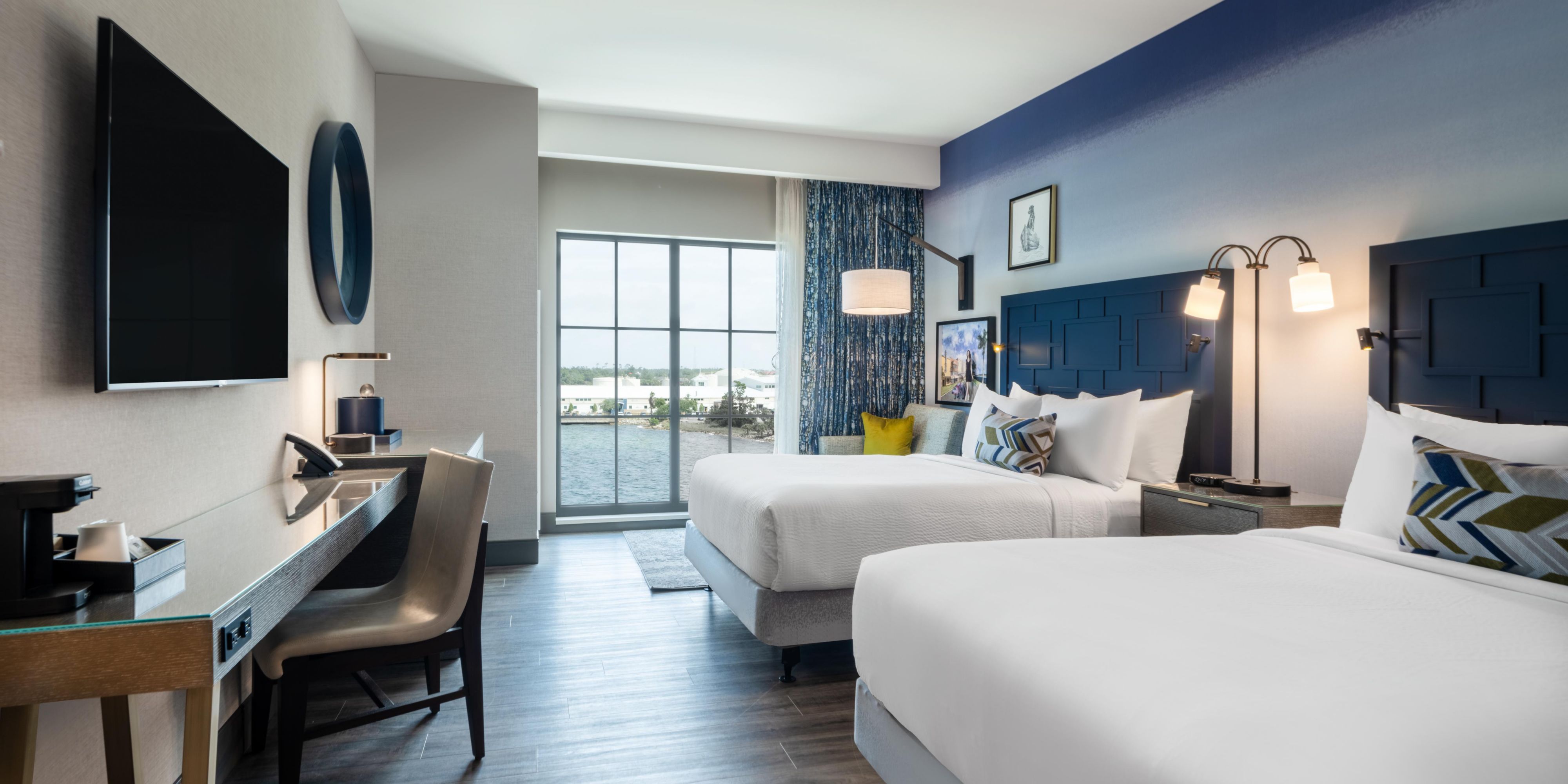 Enjoy two beds, bay views, workspace, and mini fridge.