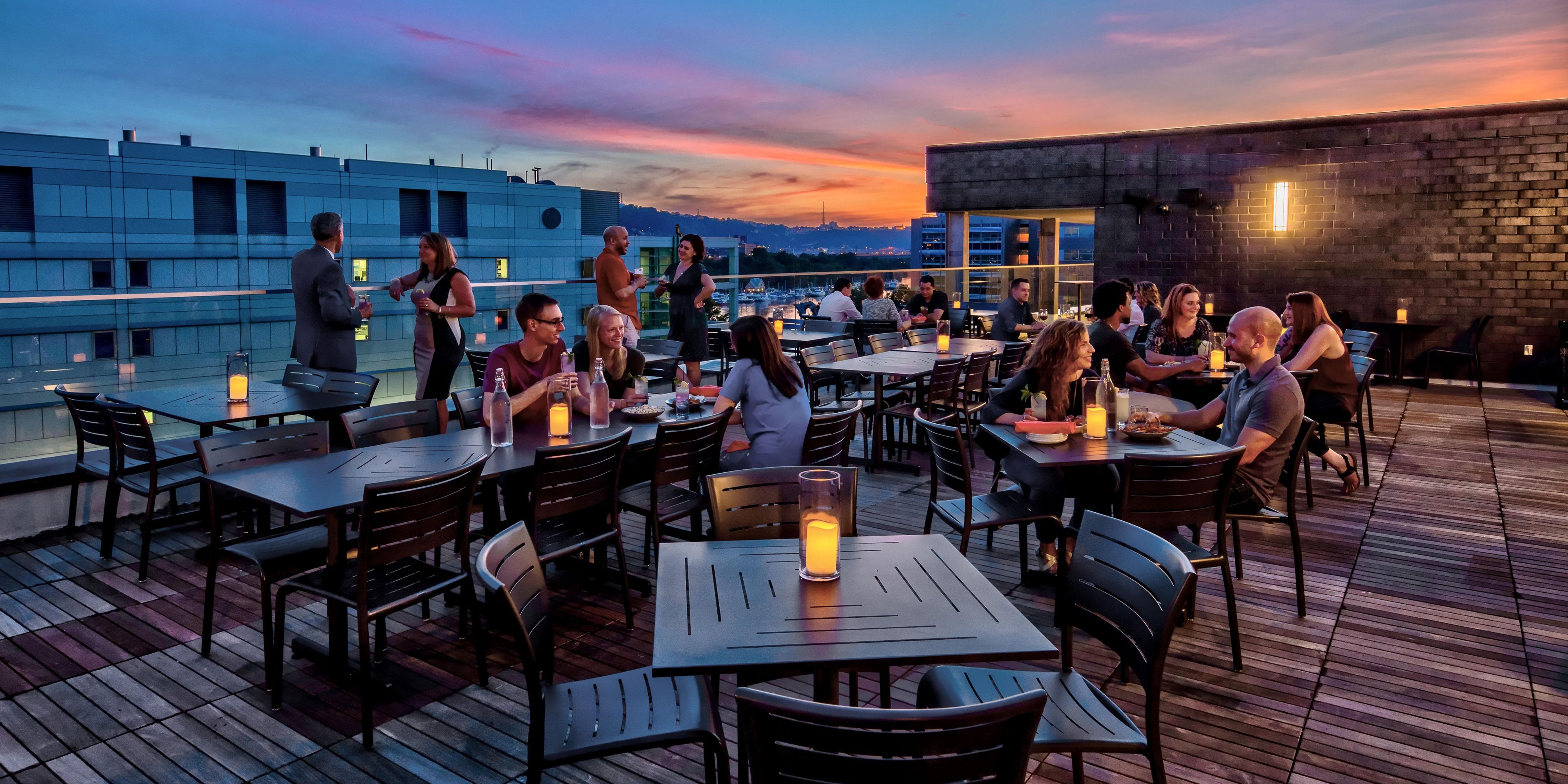 Rooftop terrace with people dining at Hotel Indigo Pitts Univ-Oak