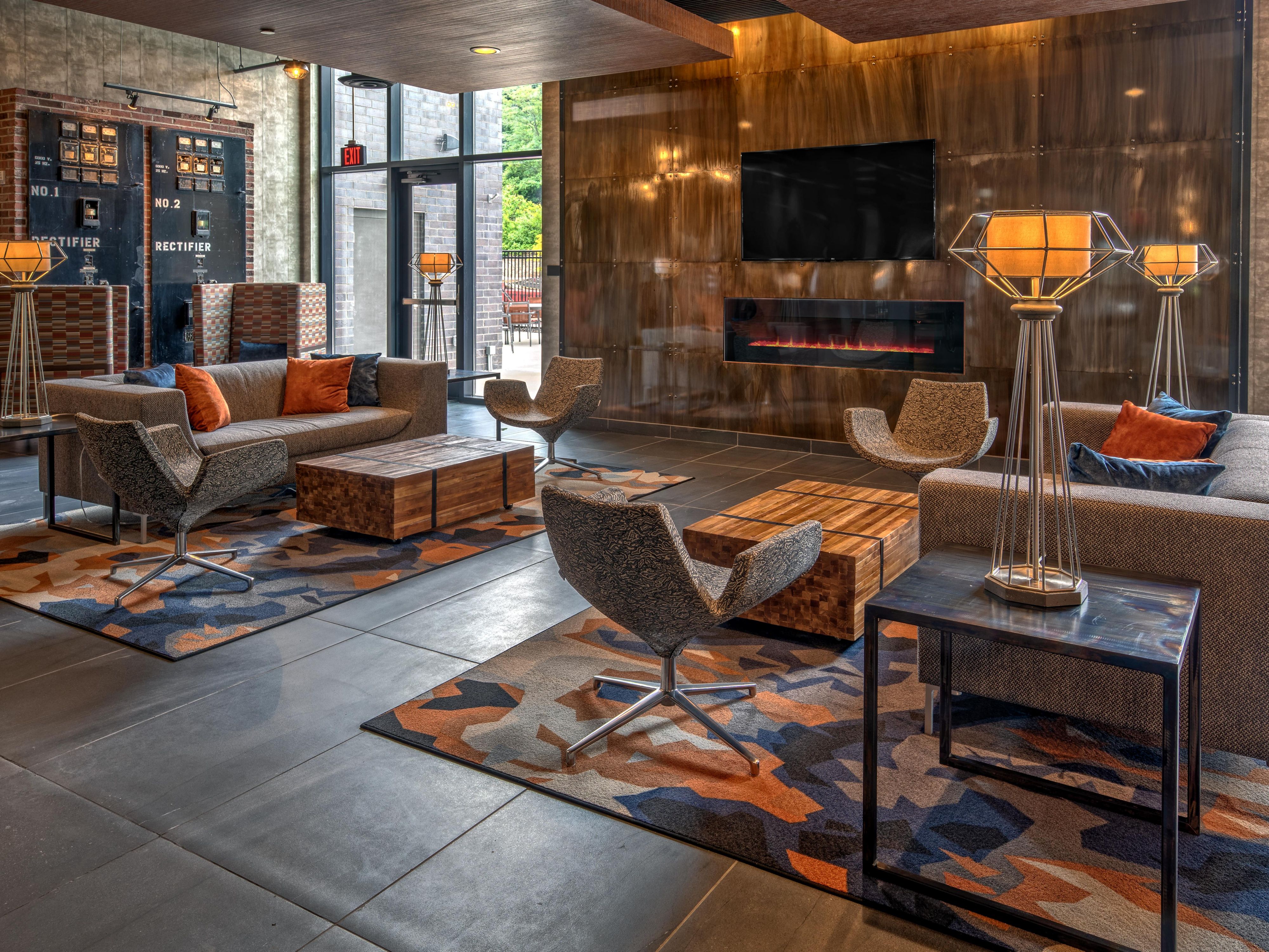 Lobby great room with sofas & fireplace at Hotel Indigo Pitts Univ