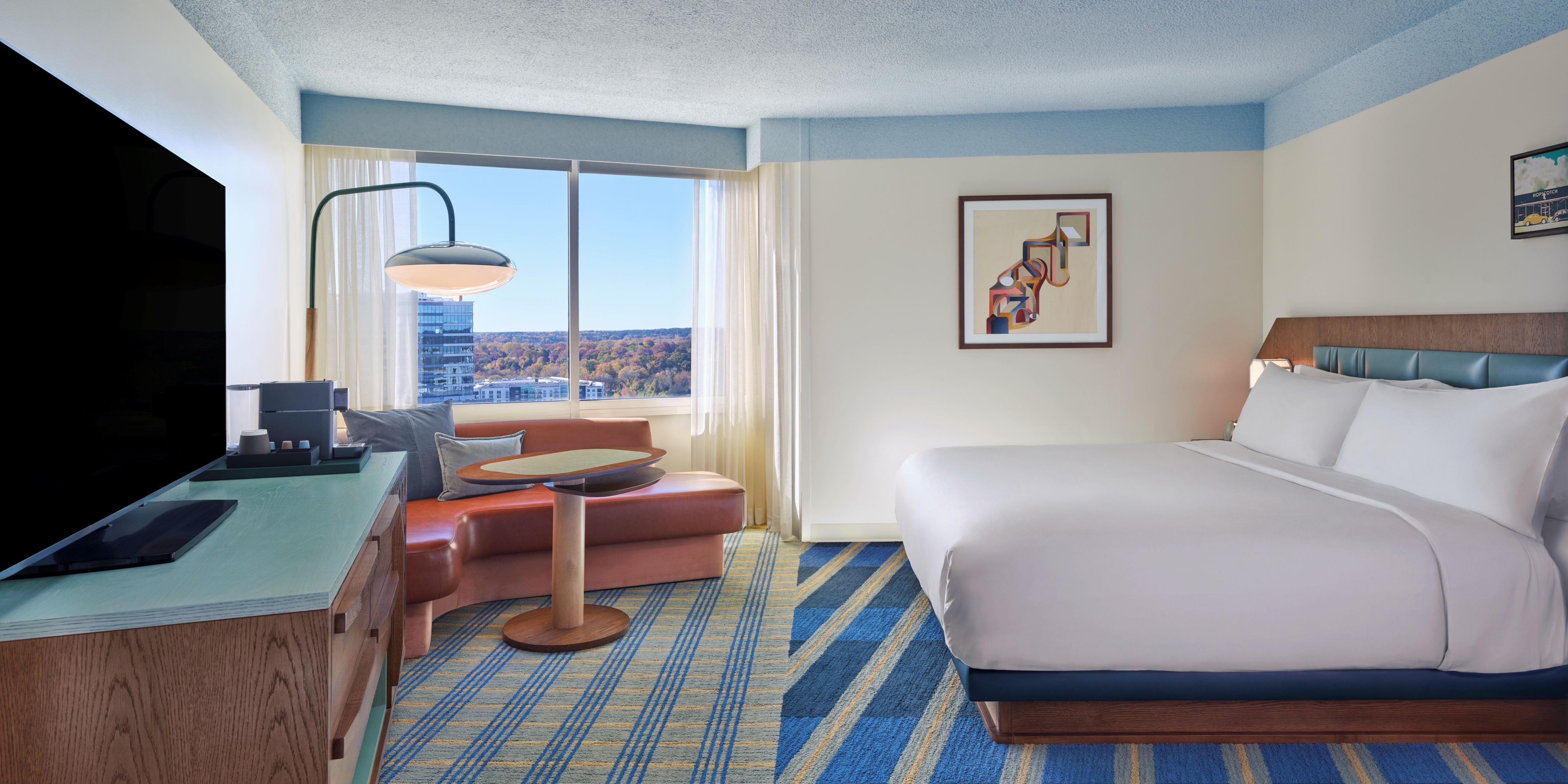 Modern King Guest Room with Scenic Views and Plush Bedding