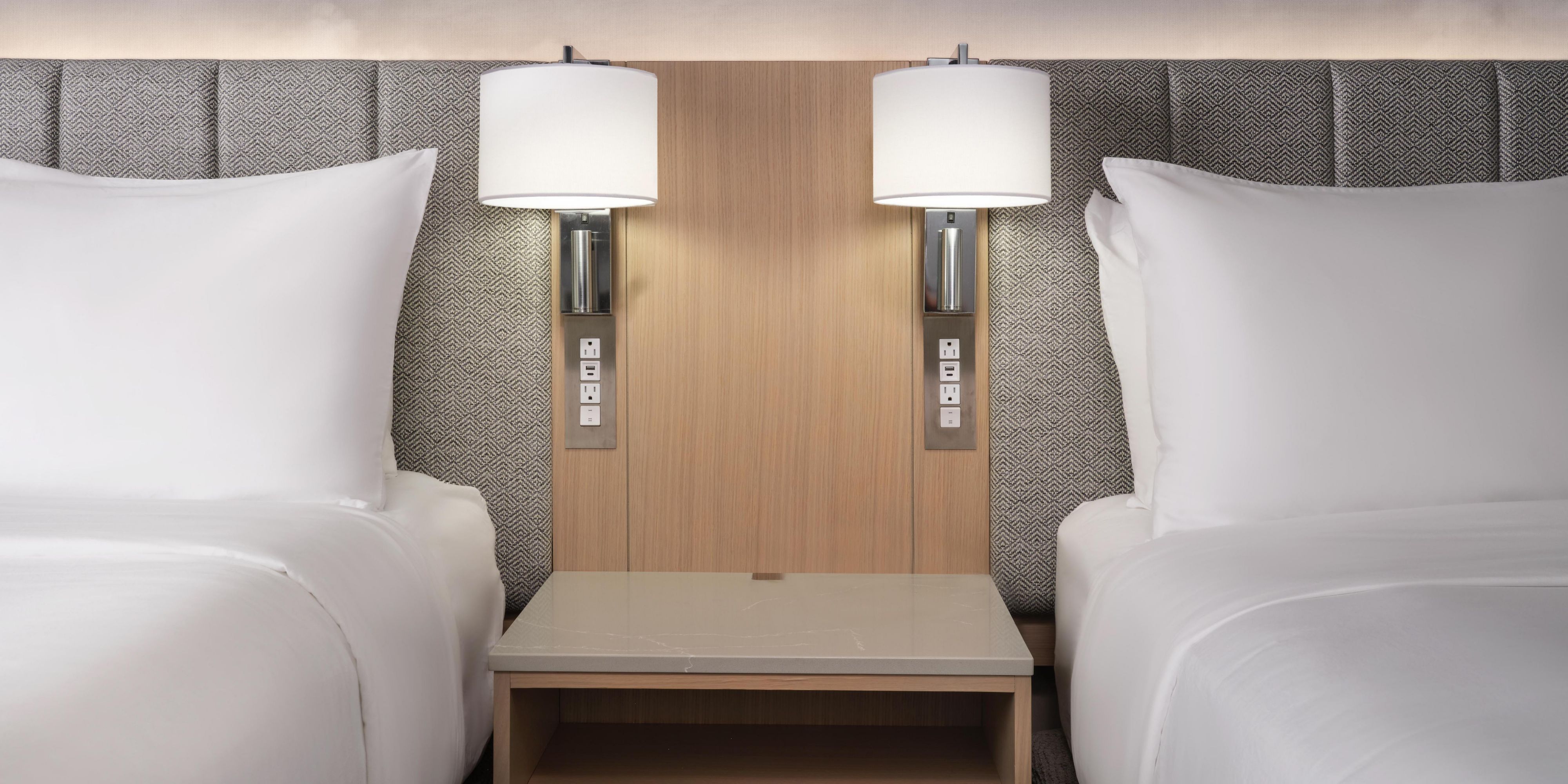 Two queen beds with a shared nightstand for added ease.