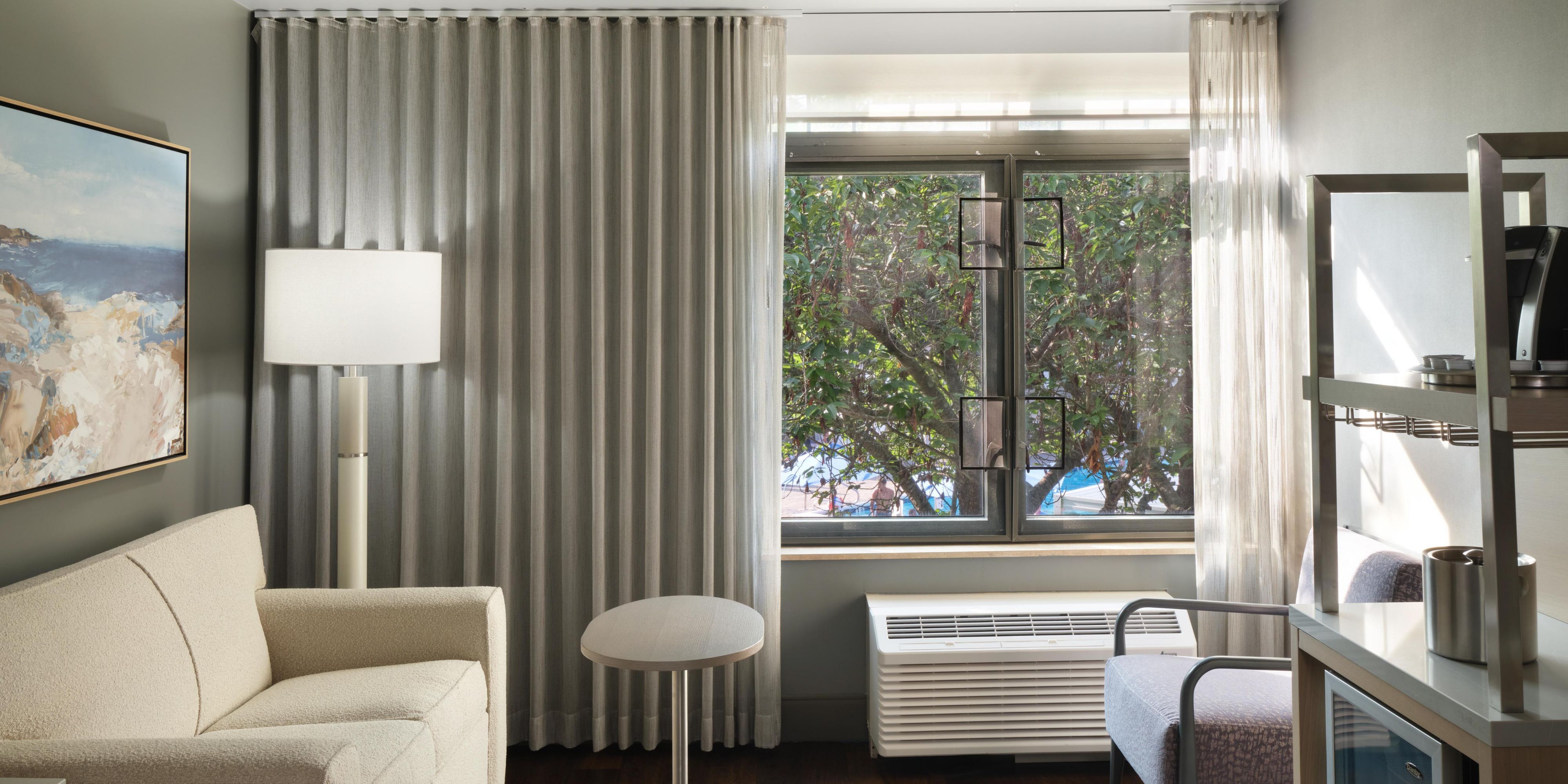 Premium king rooms overlook lush greenery and the pool.