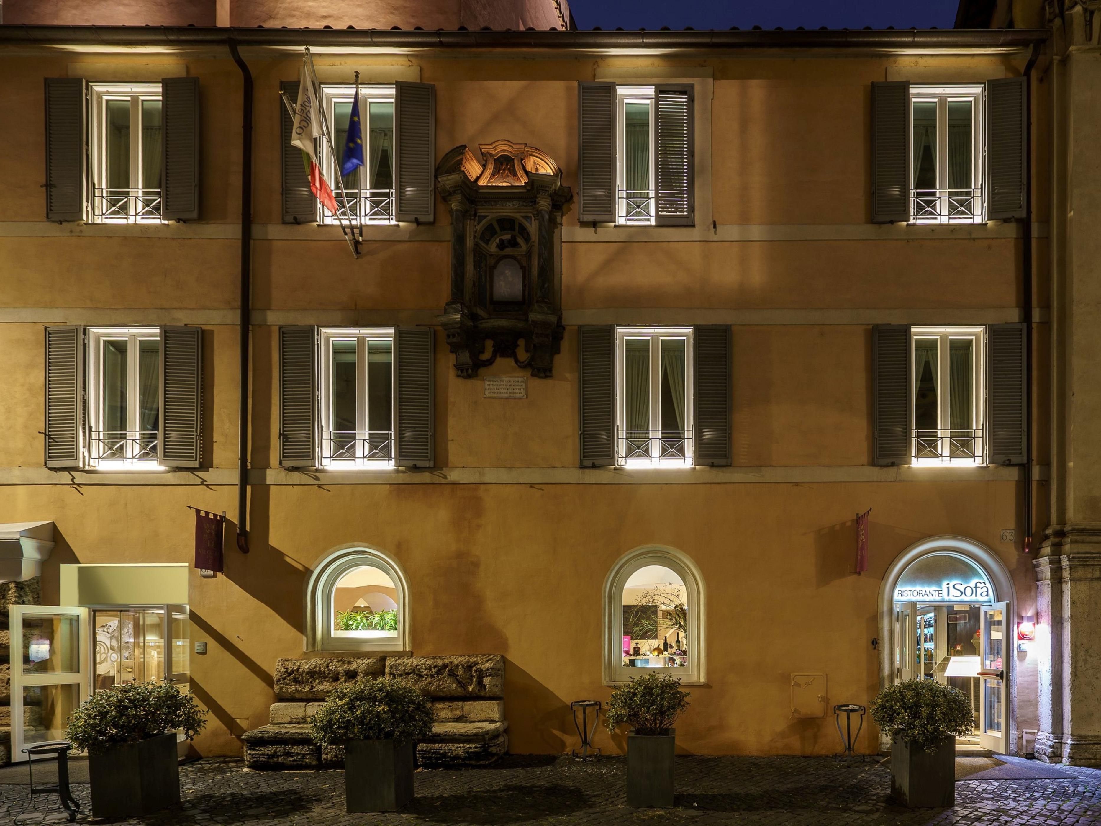 The large travertine marble stones at the base of the facade