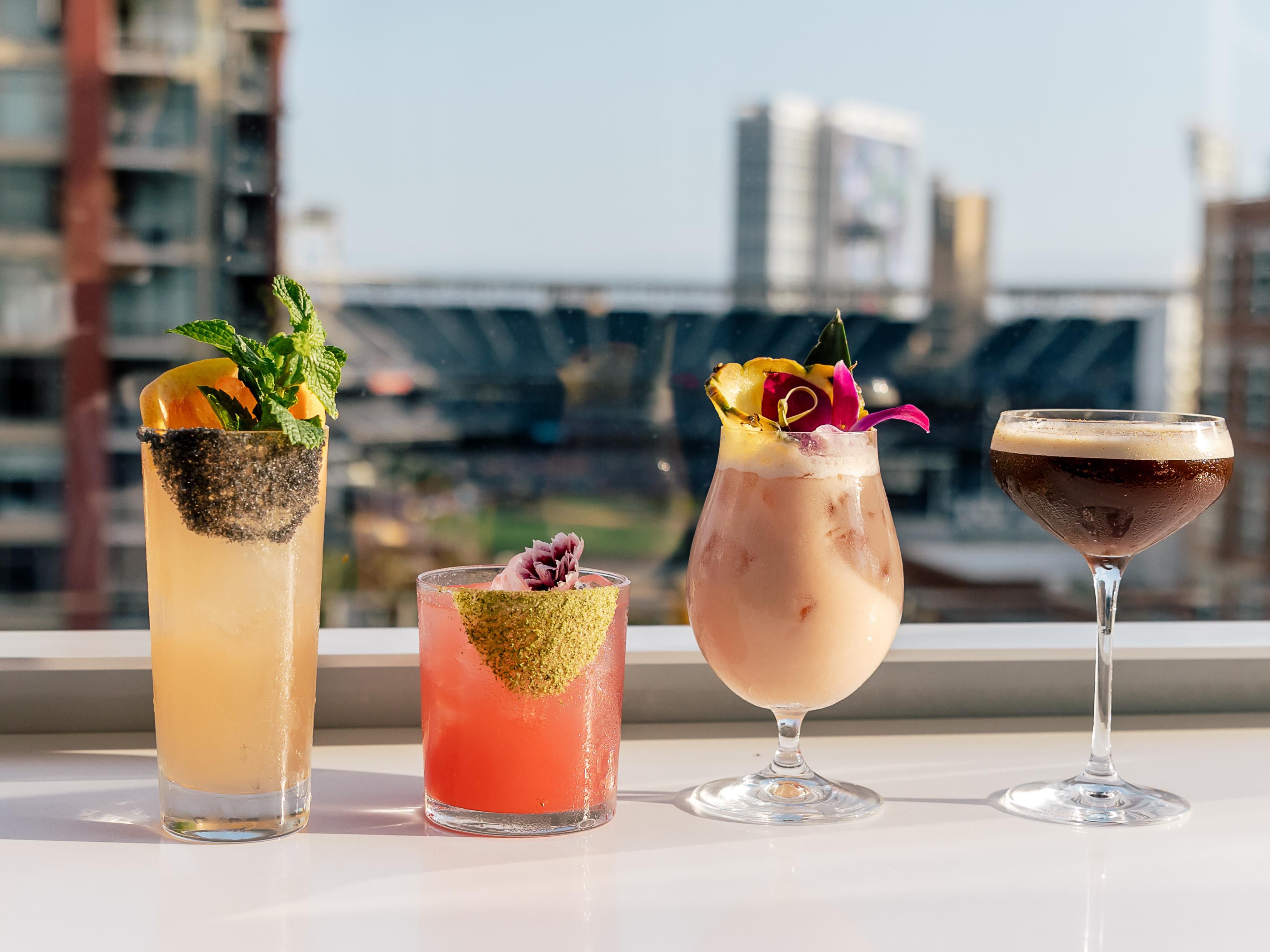 cocktails on rooftop with view of Petco Park