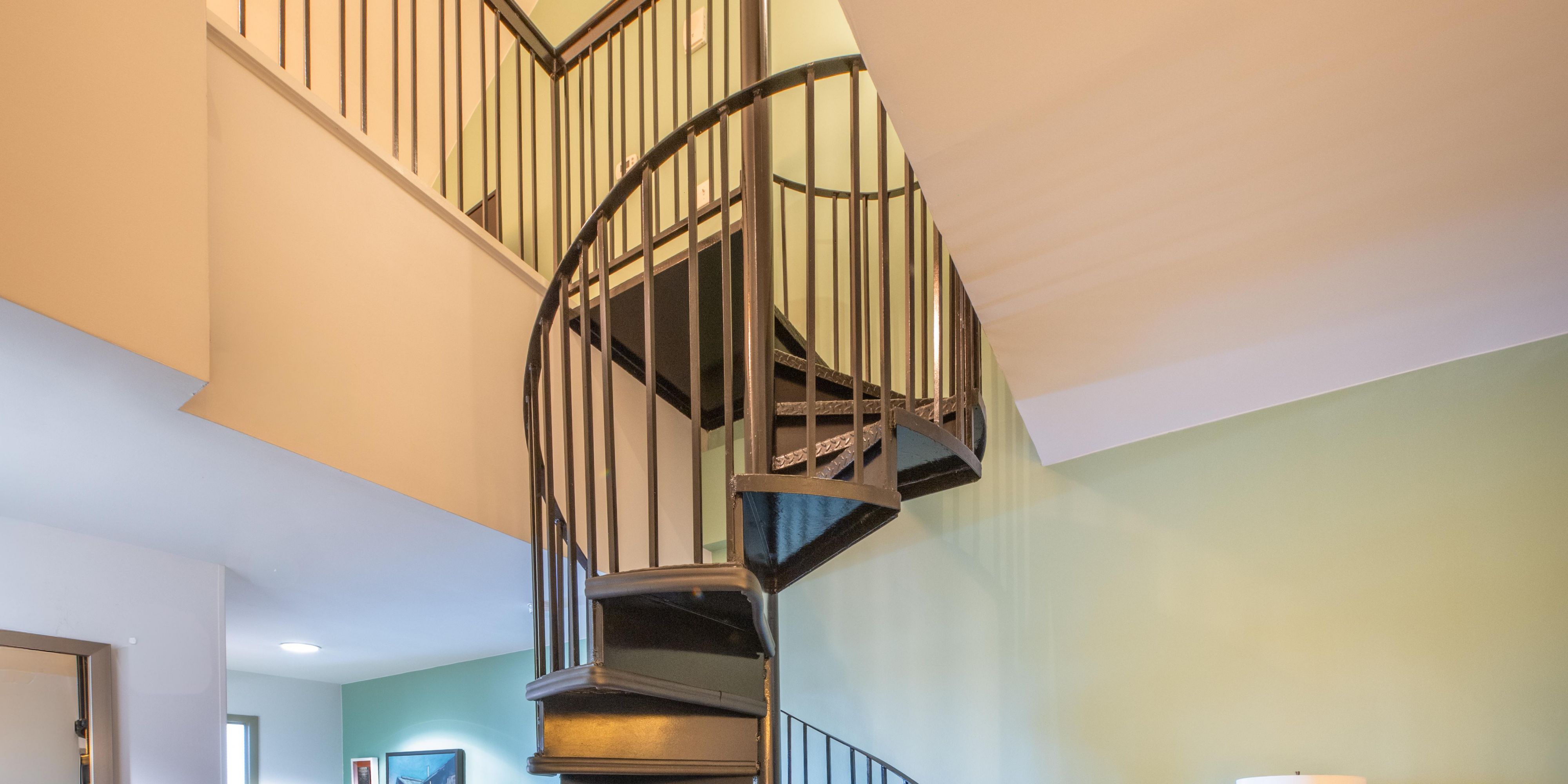 A spiral staircase connects the two levels of your suite.