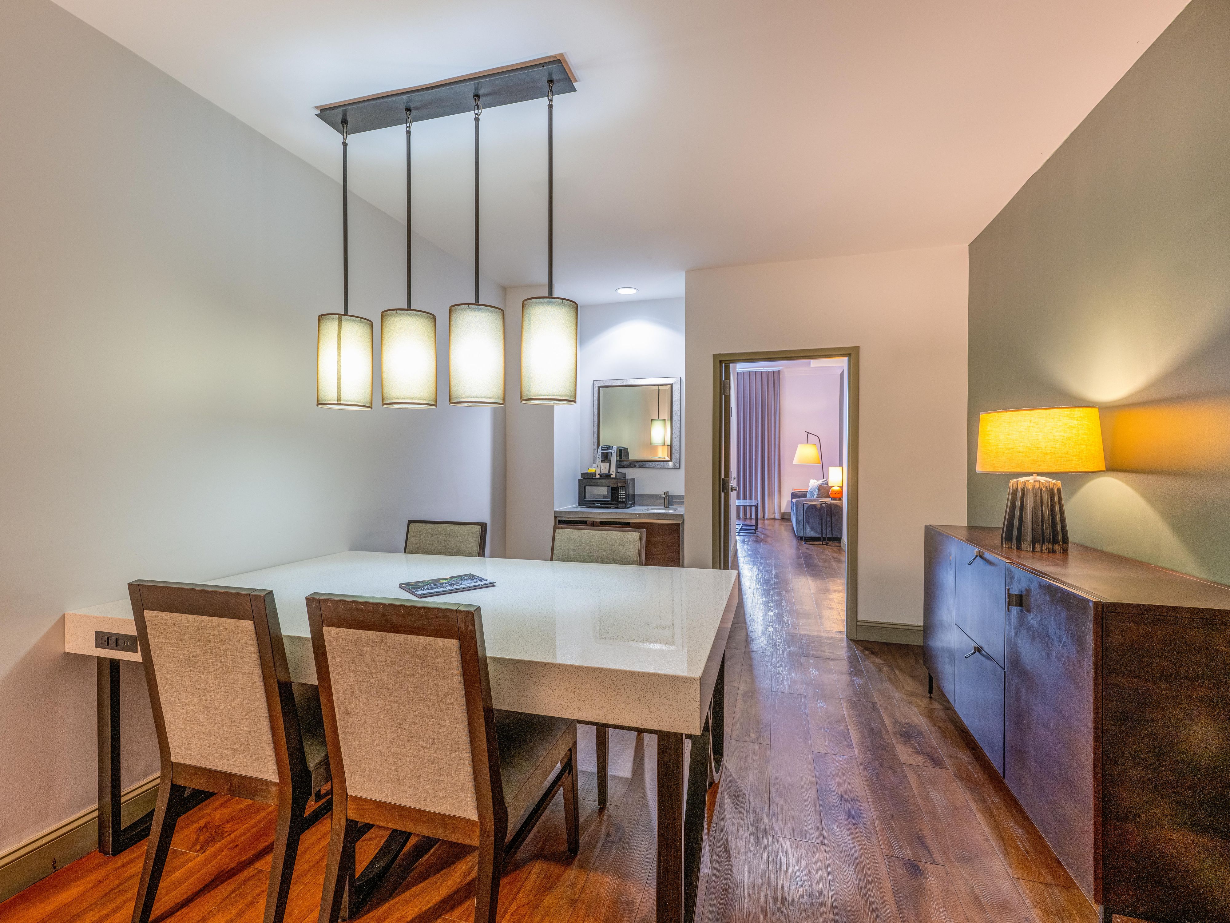 Share a meal around the dining table in your suite.