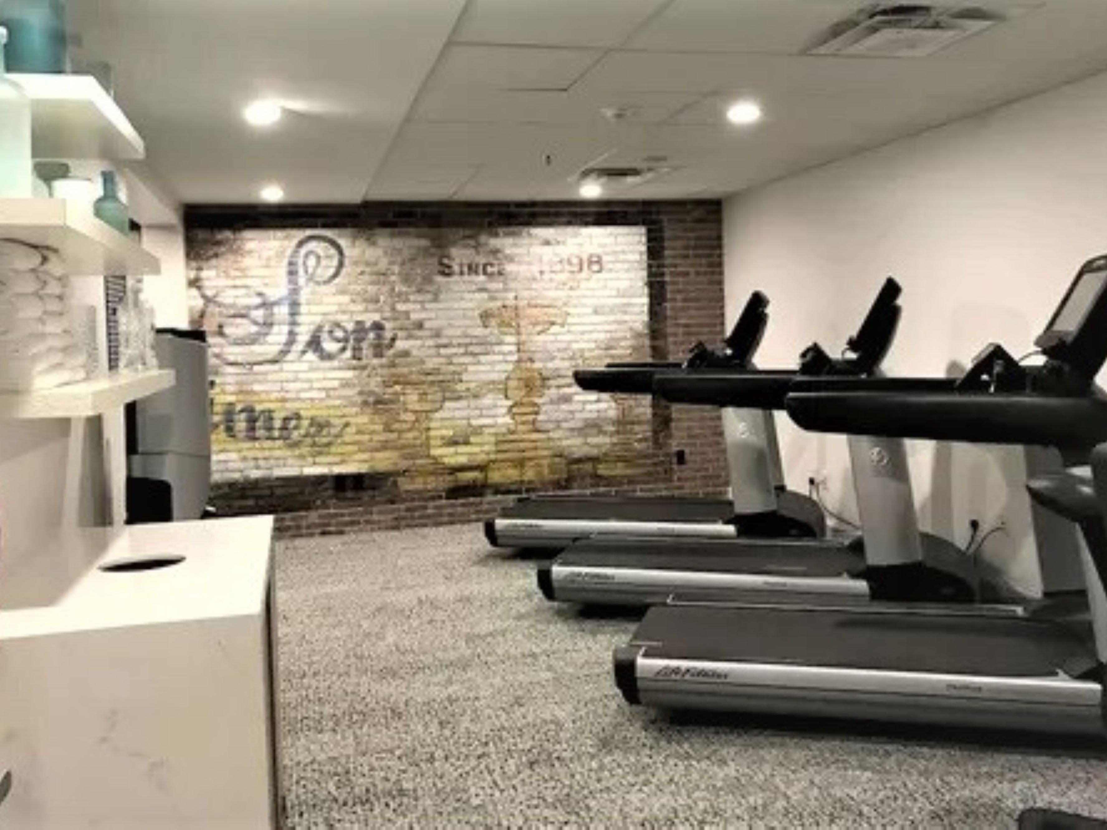 Fitness Center with cardio equipement, weights, and benches.