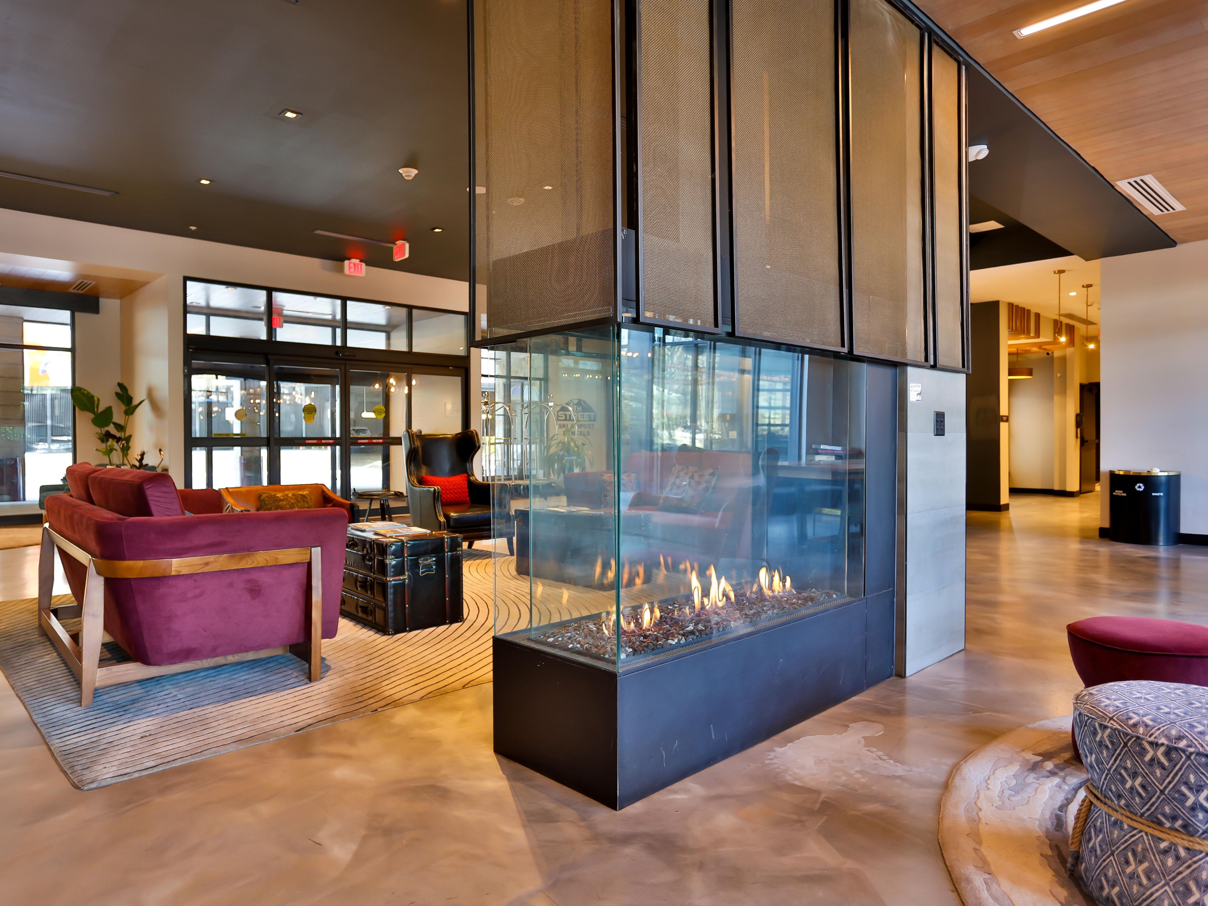 Cozy up next to lobby fireplace with friends or a book.