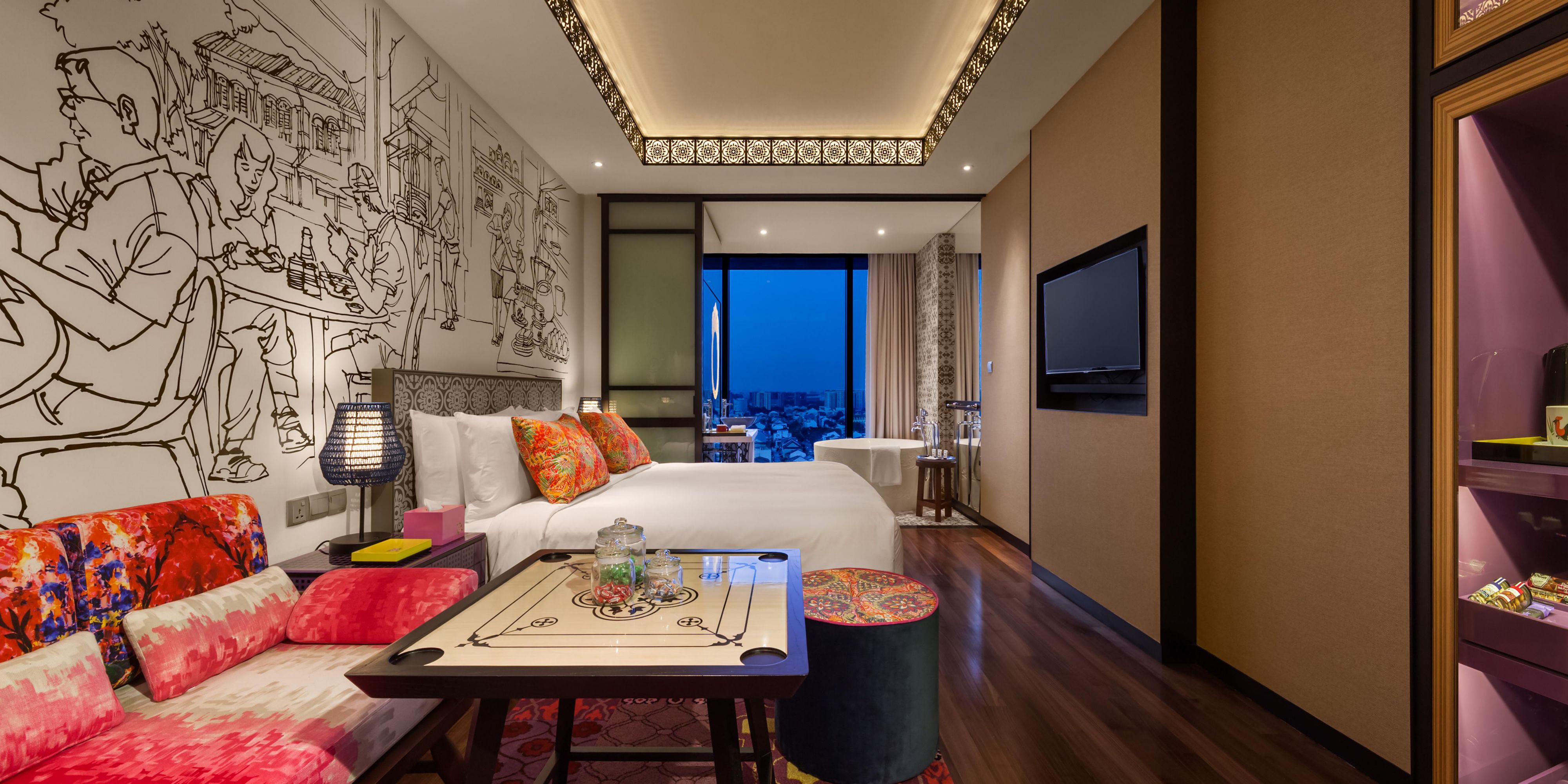 A king-sized bed with a cozy seating area