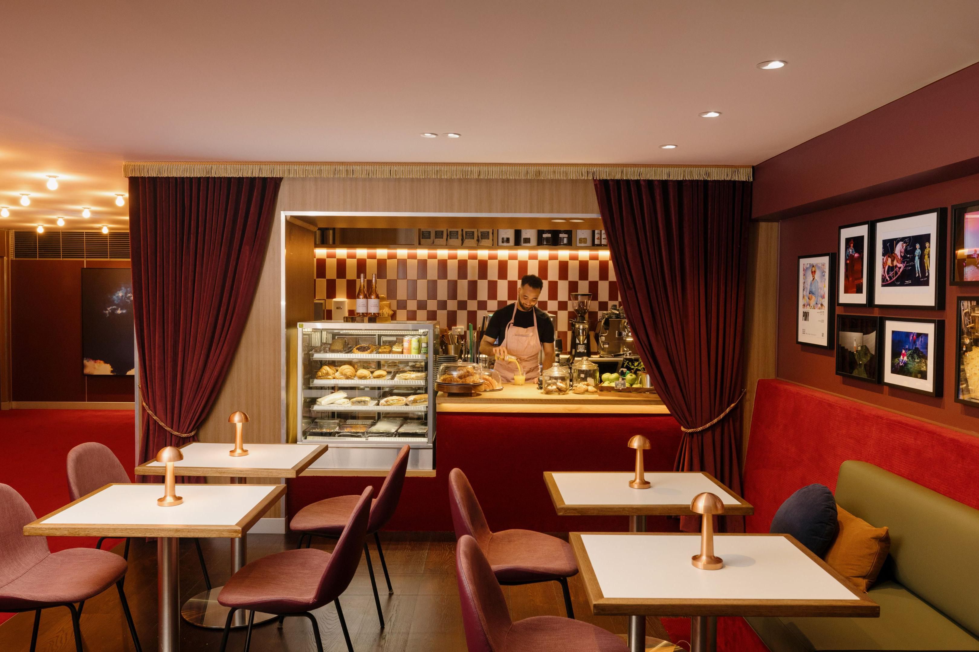 Delve into fresh espresso coffee and snack at 'The X', alongside our theatre-like lobby, lined with glamorous copper-coloured curtains and a series of portraits by Gary Heery.