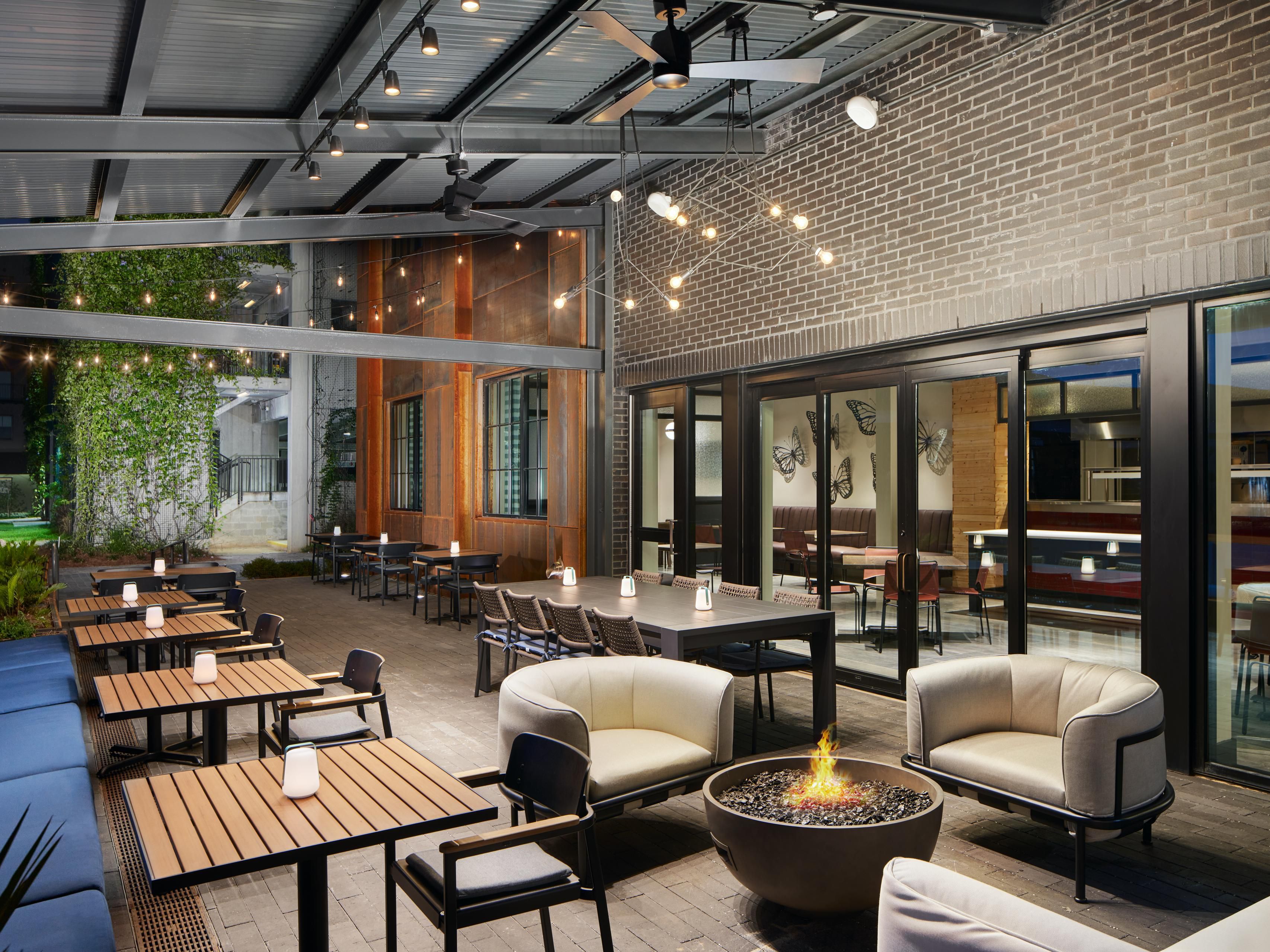 R&R Eatery patio with a fire pit, booth, and table seating.