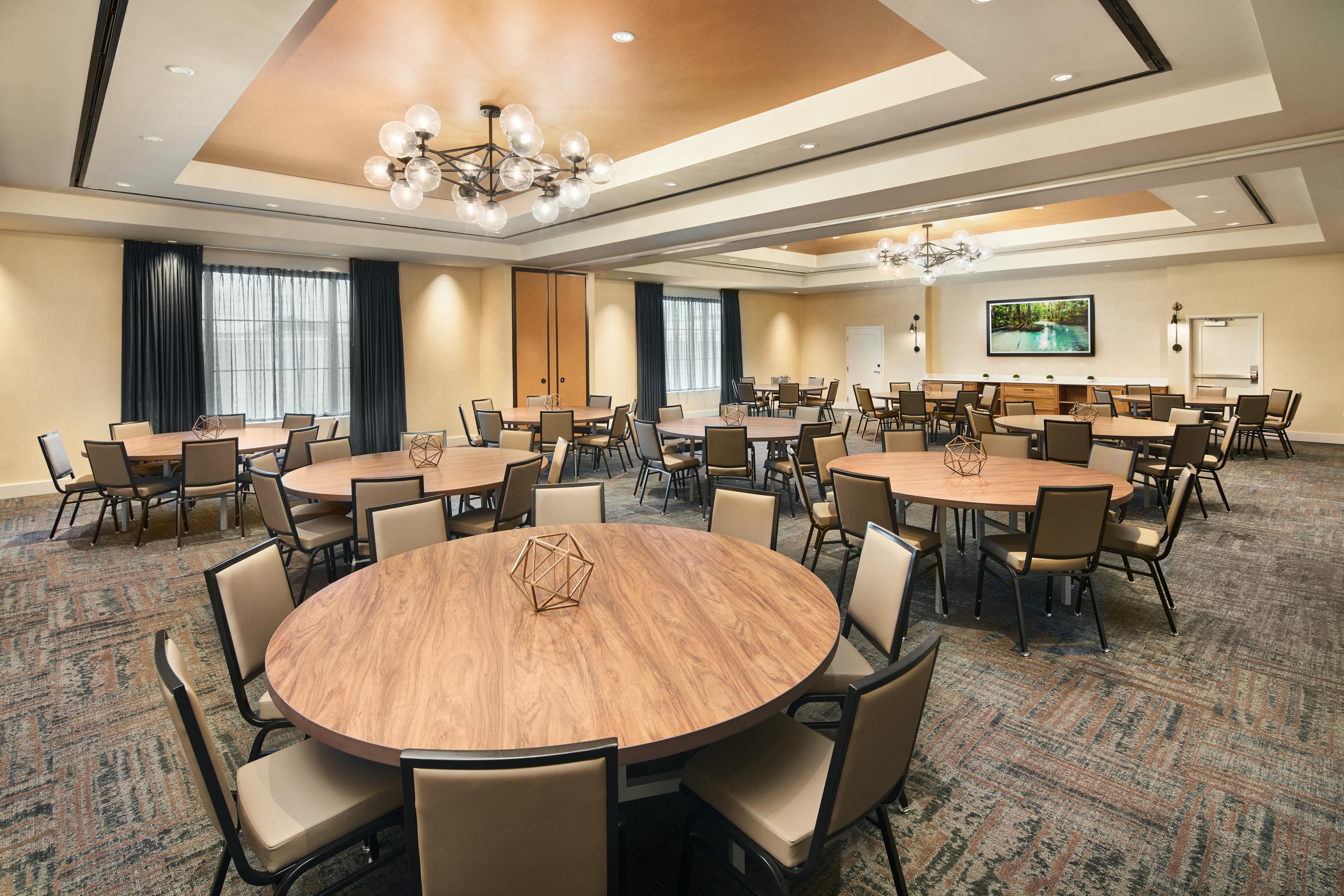 A modern event space with round tables.