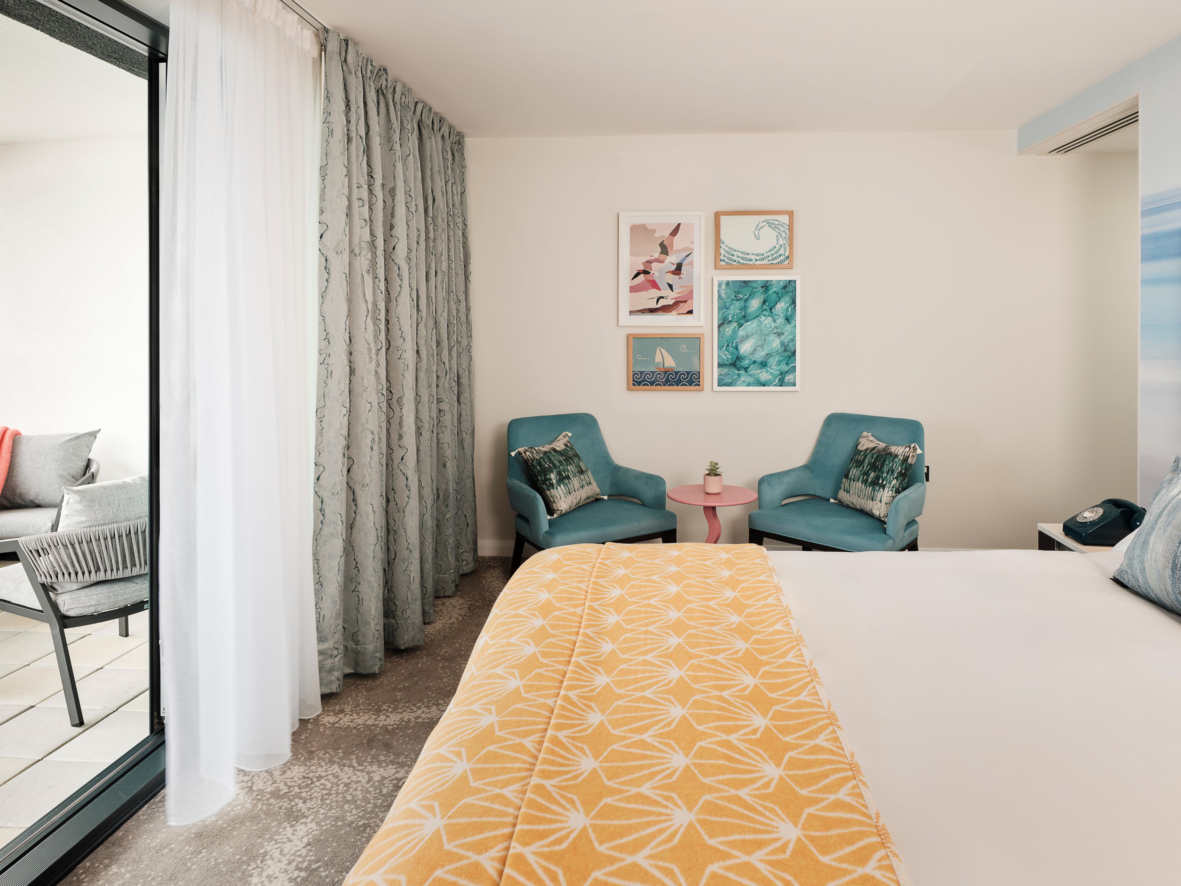Relax on your private balcony with Torquay sea views.