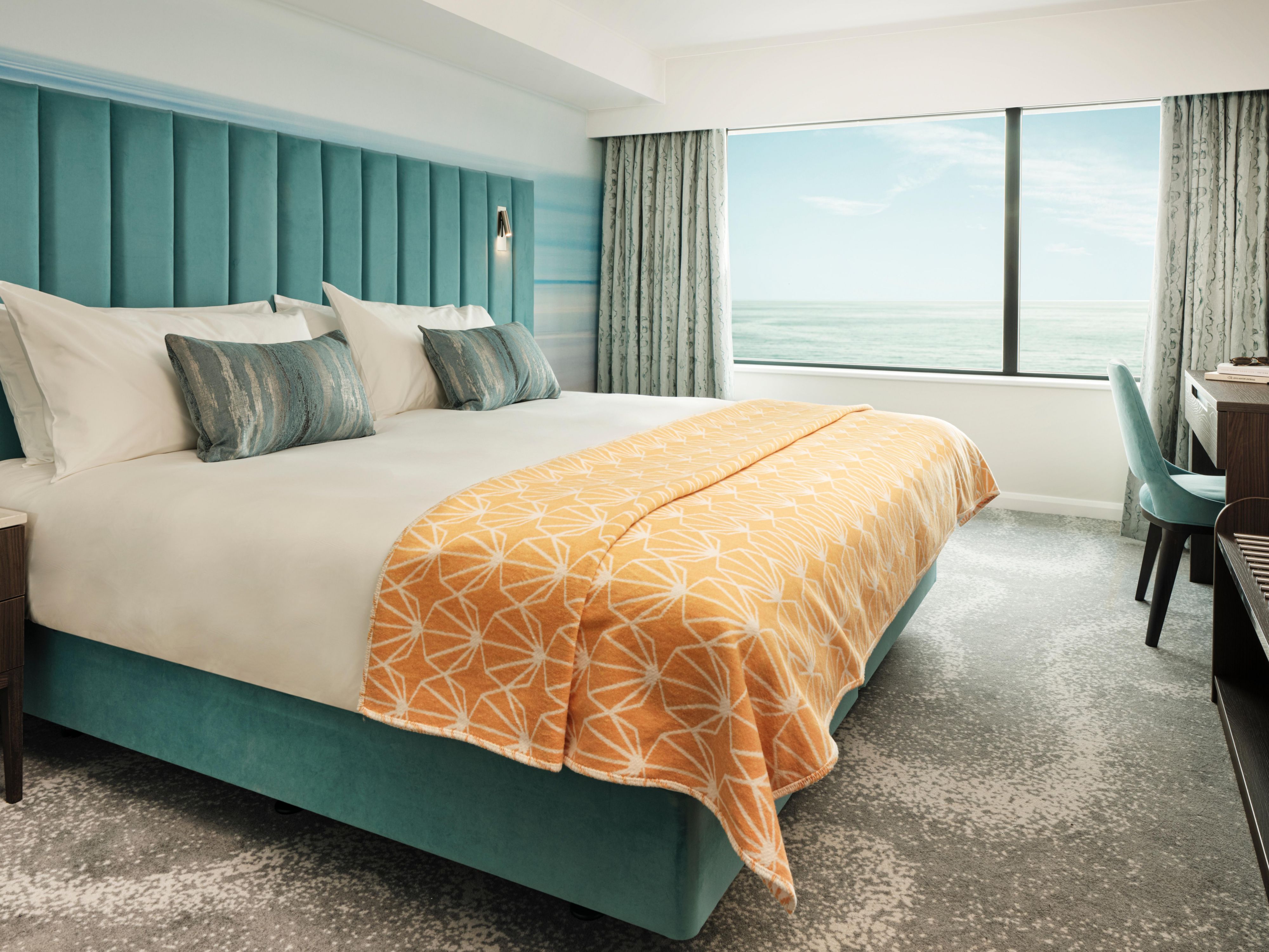 Unwind in a boutique room with soft bedding and scenic views.