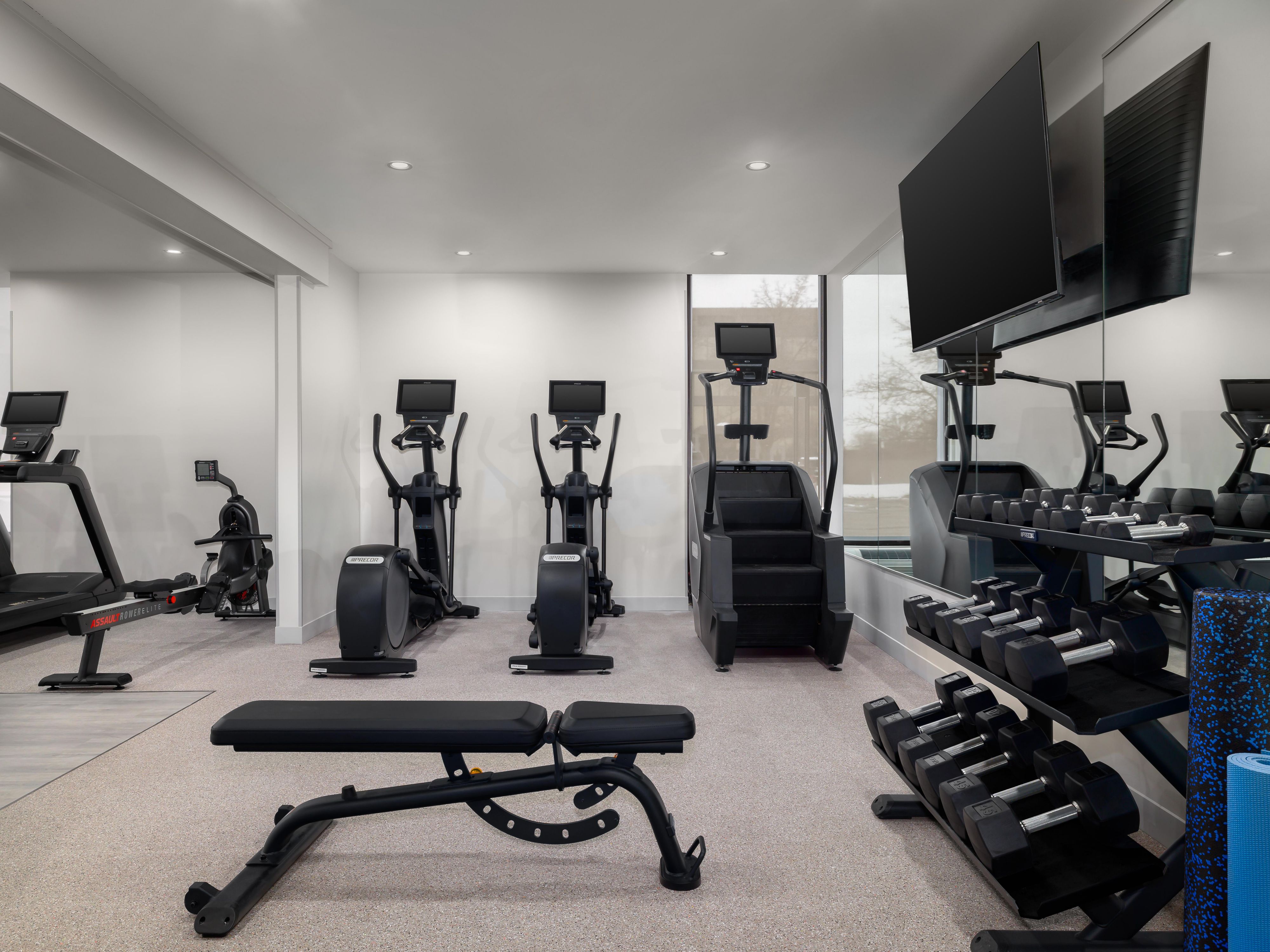 Guest fitness center with weights and machines.