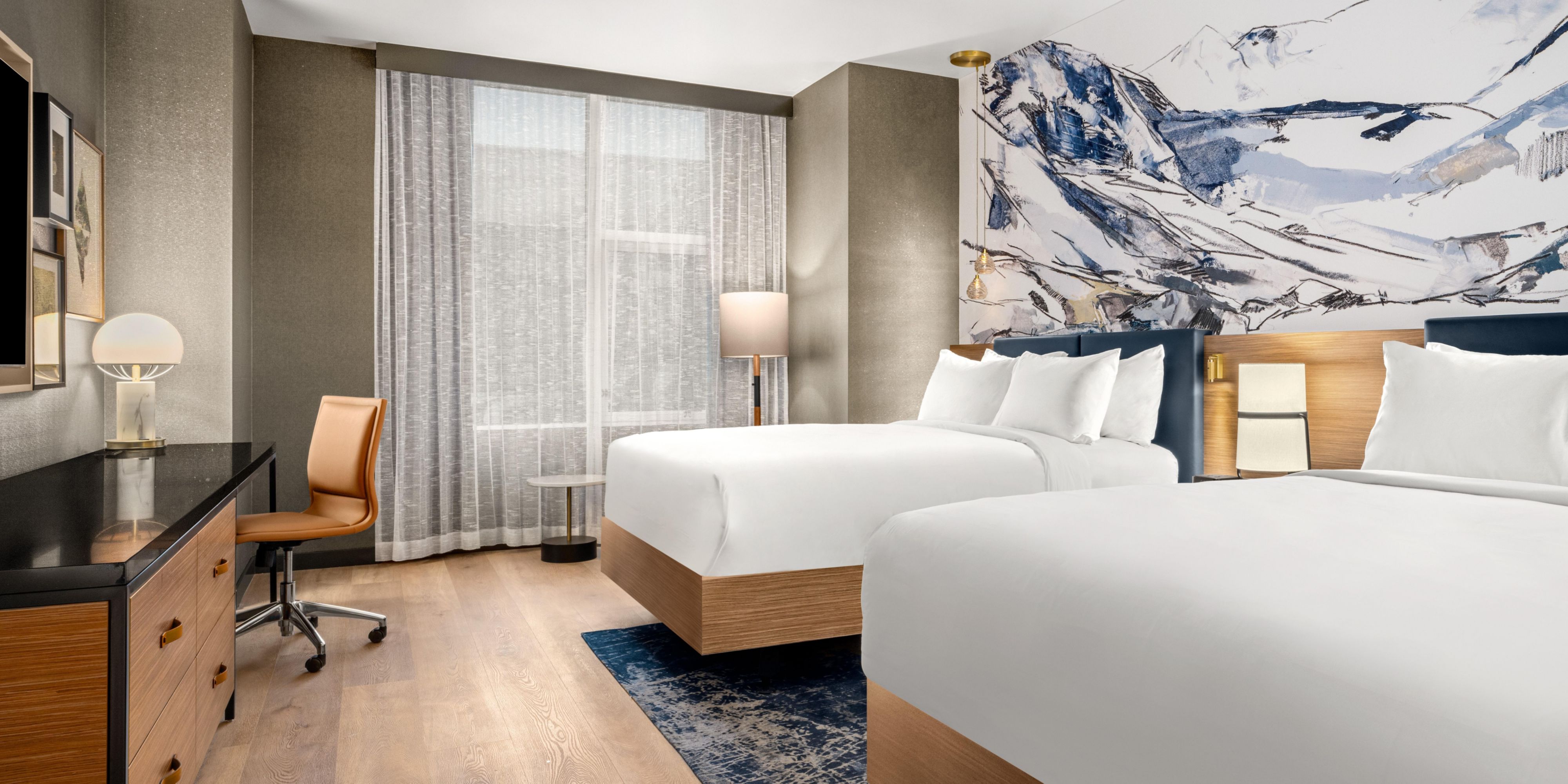 Recharge after a day of exploring in our ADA two-queen guest room.