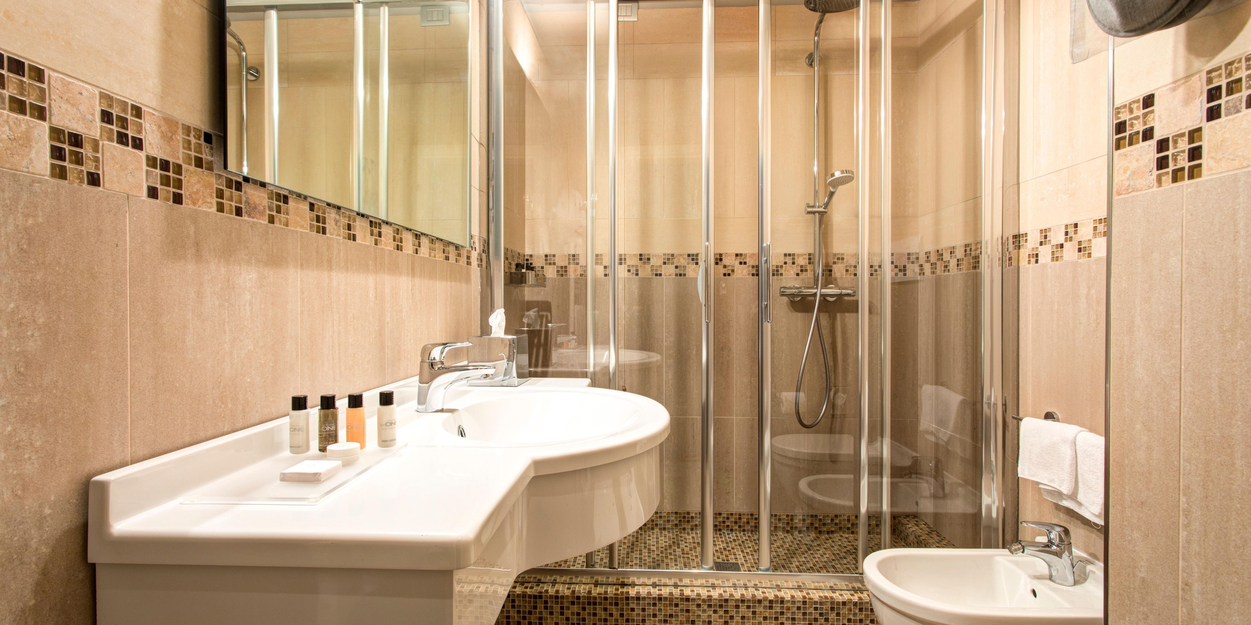 Spacious Premium Rooms bathroom with luxury toiletry set.