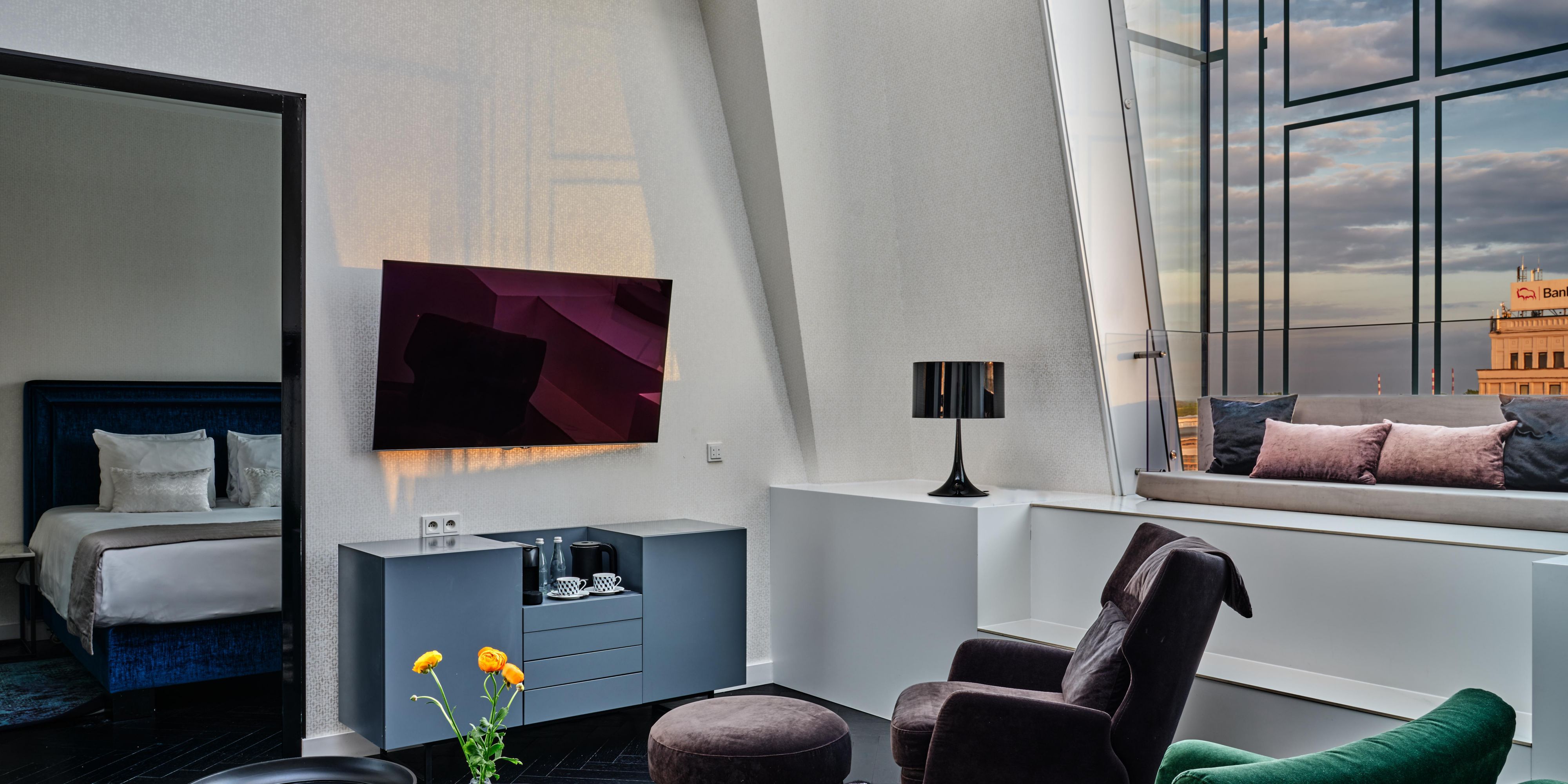 The living space is a stylish interior, equipped with an LCD TV.