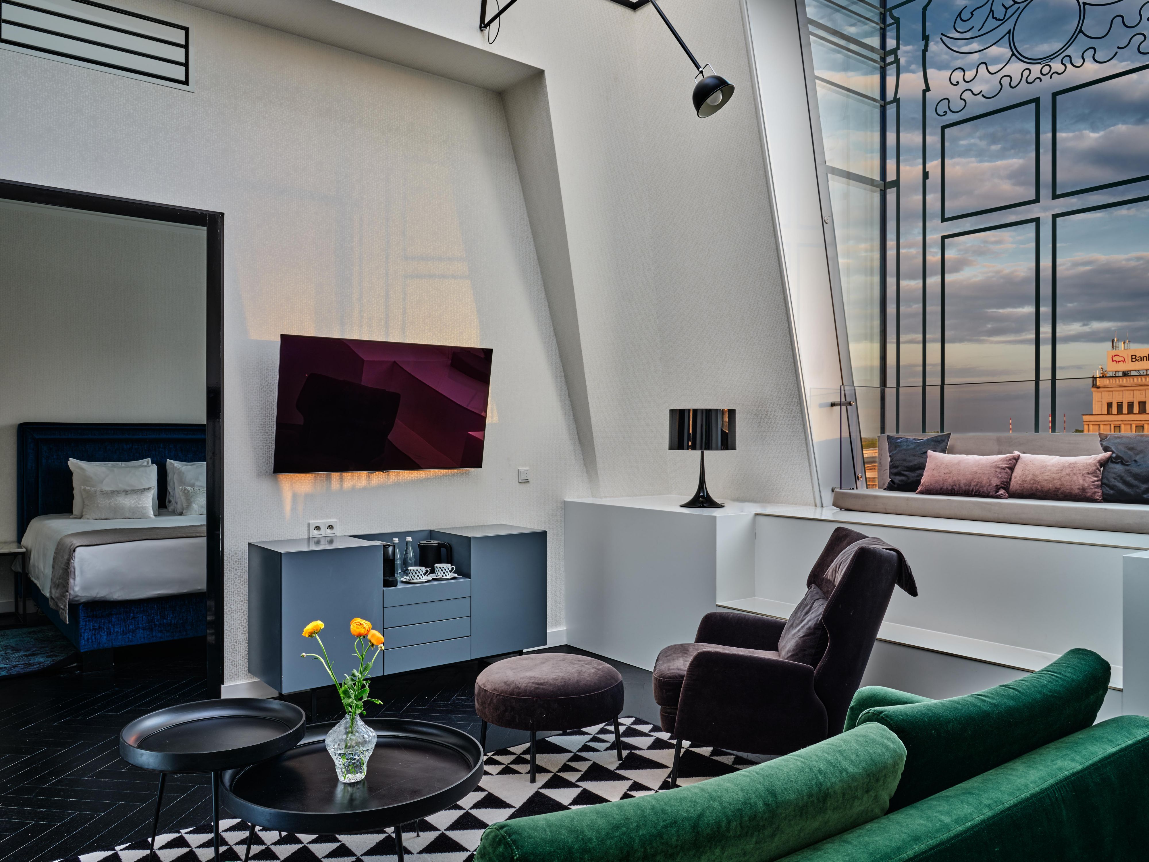 The living space is a stylish interior, equipped with an LCD TV.