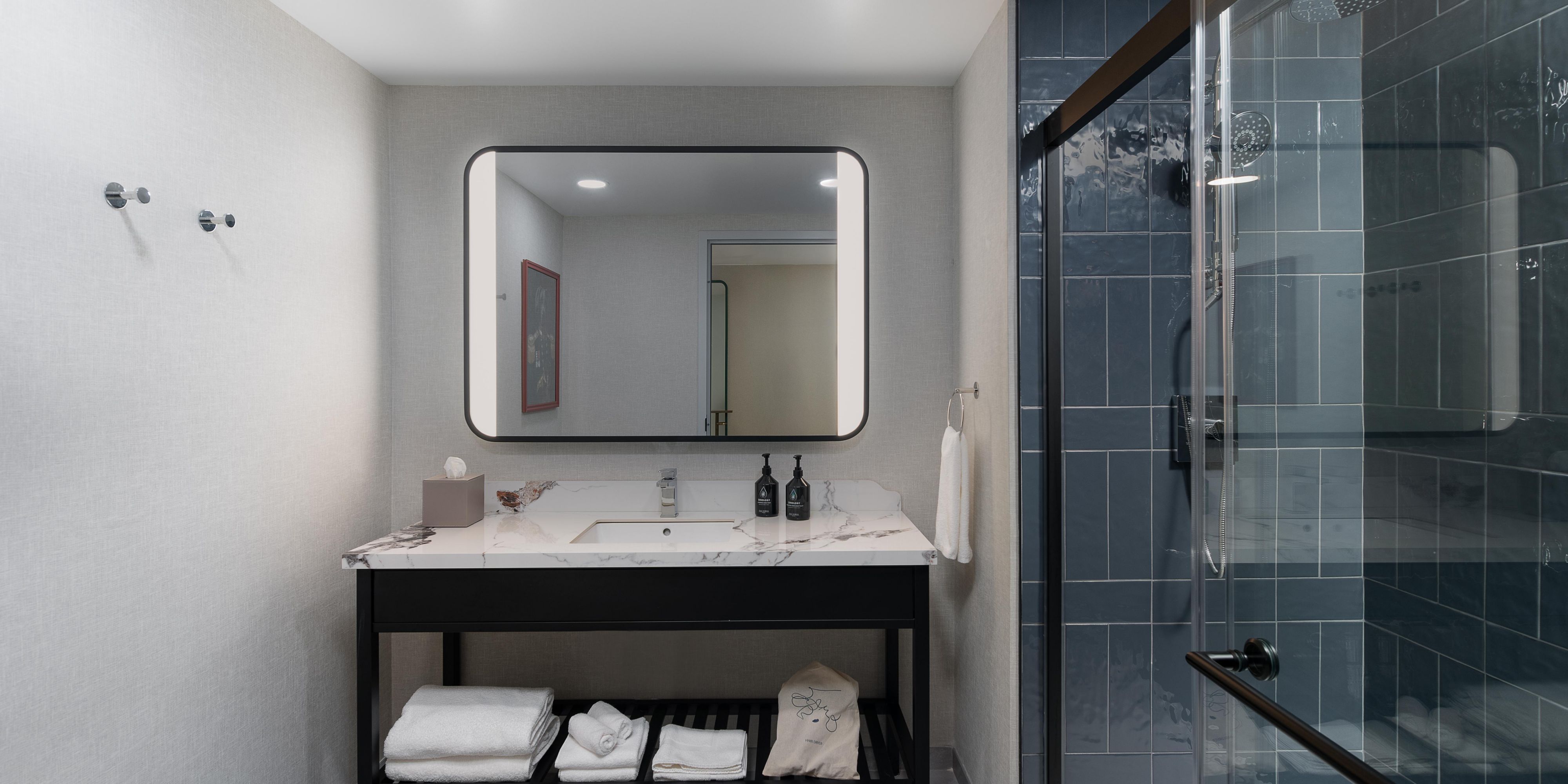 Spacious, marble-finished bathroom with walk-in shower.