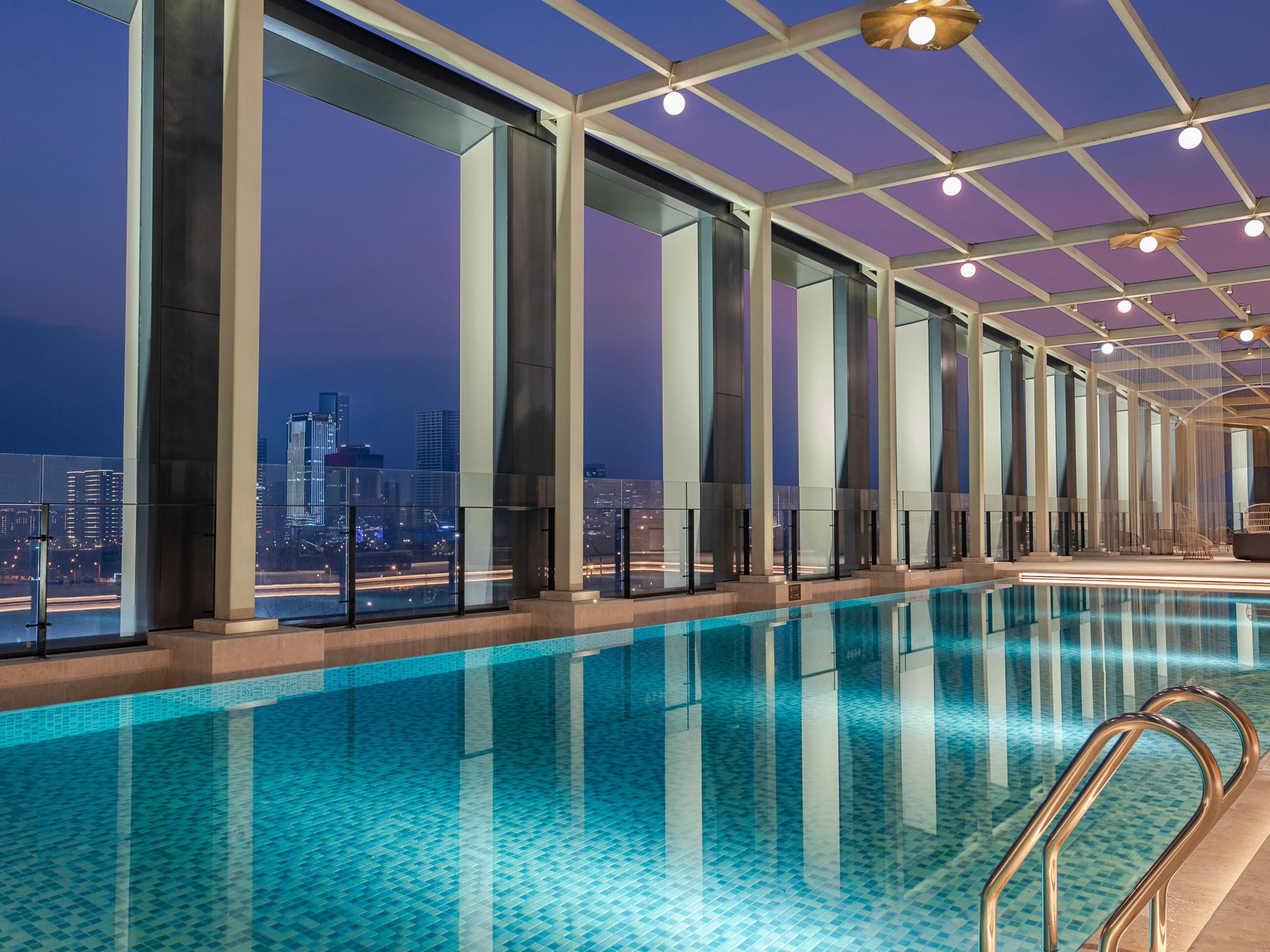 The fitness center is located on the RF floor of the hotel, featuring an indoor gym and an outdoor swimming pool.