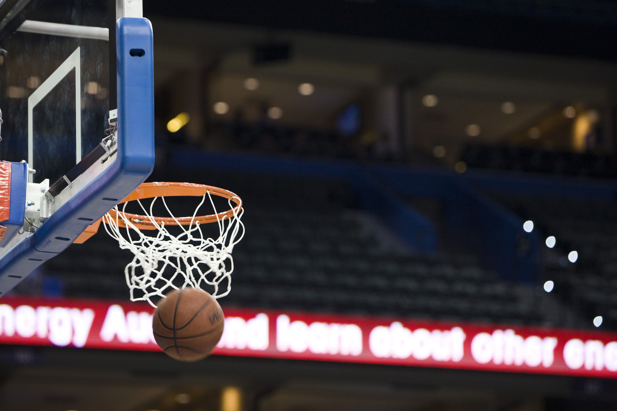 Basketball passing through the hoop during a game