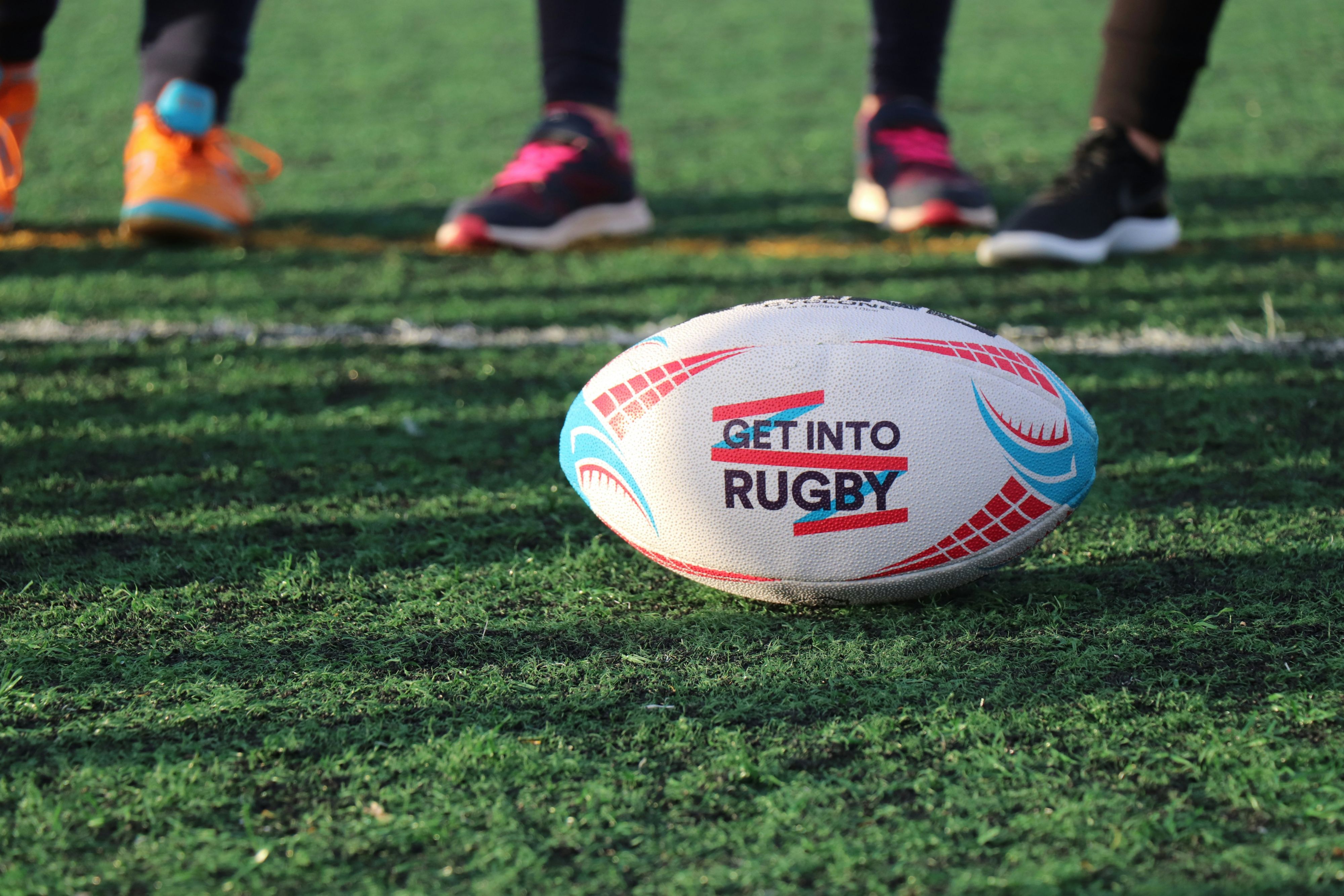 Rugby ball resting on a sports field before play