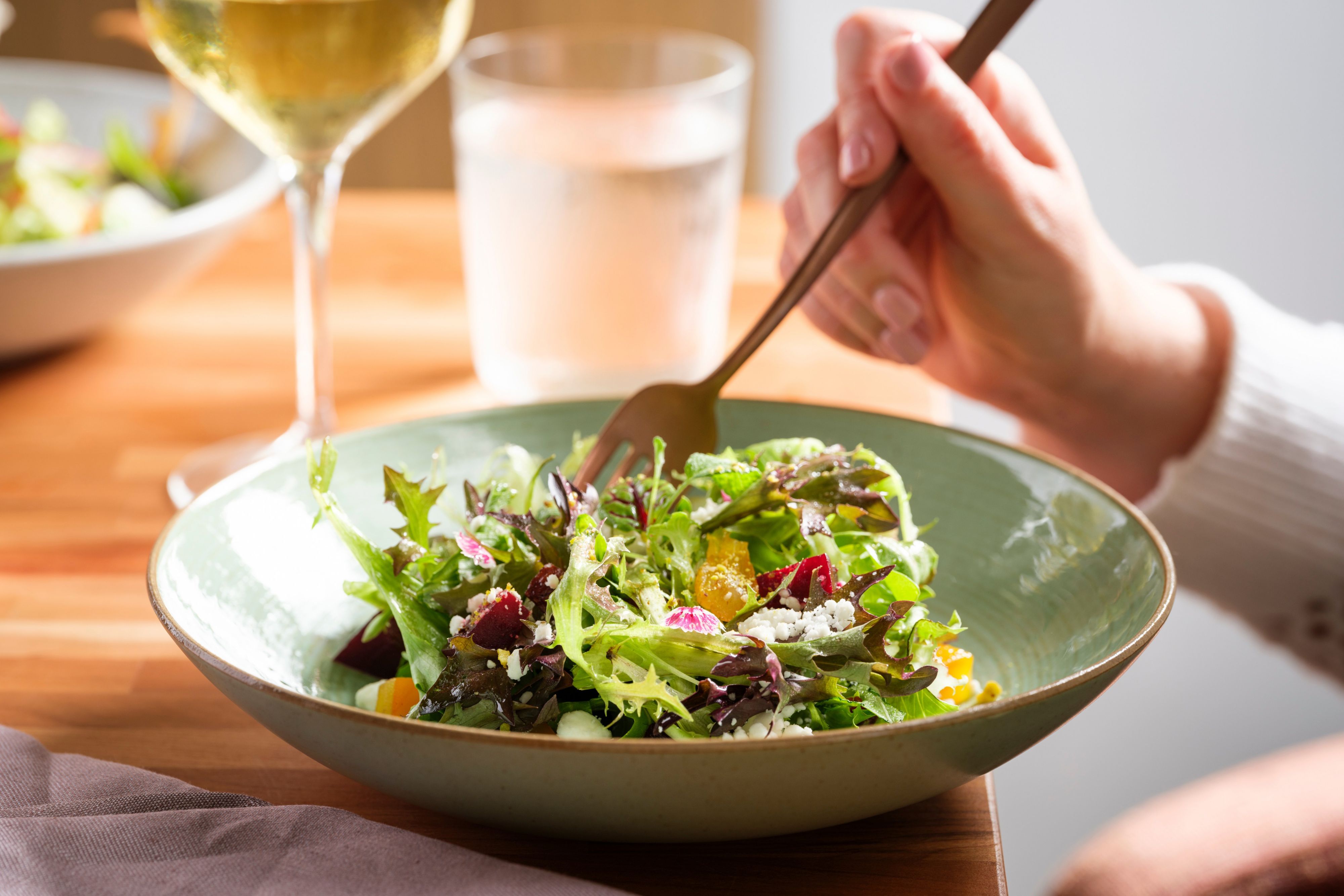 Fresh mixed greens salad served at a dining table