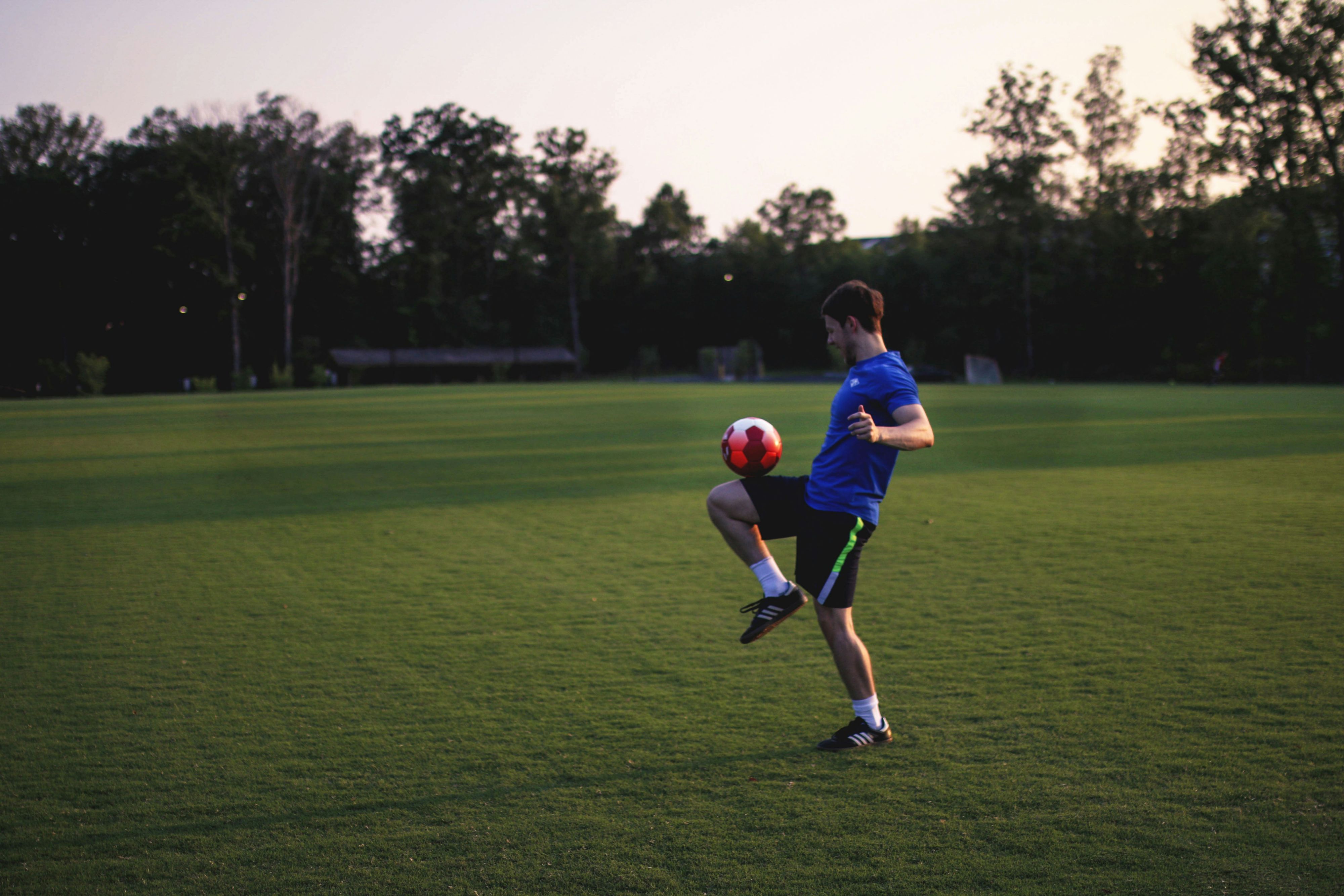 Athlete practicing ball control on a soccer field