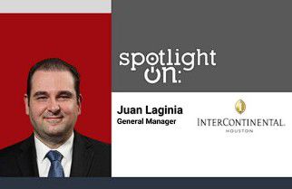 teacup on saucer next to notepad and pen on a conference table