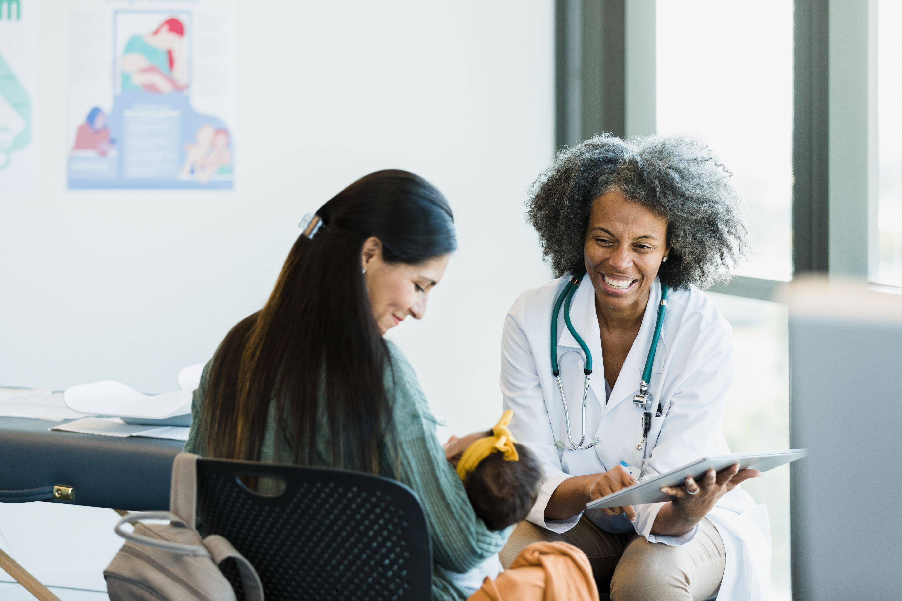 doctor talking with a mother and baby