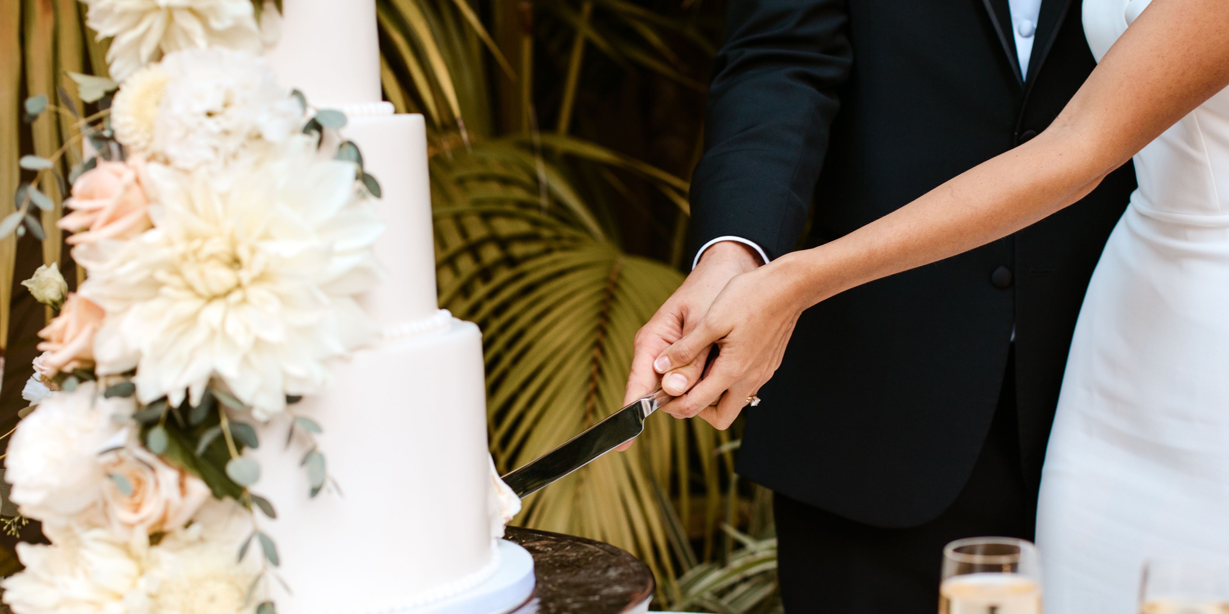bride and groom cutting wedding cake