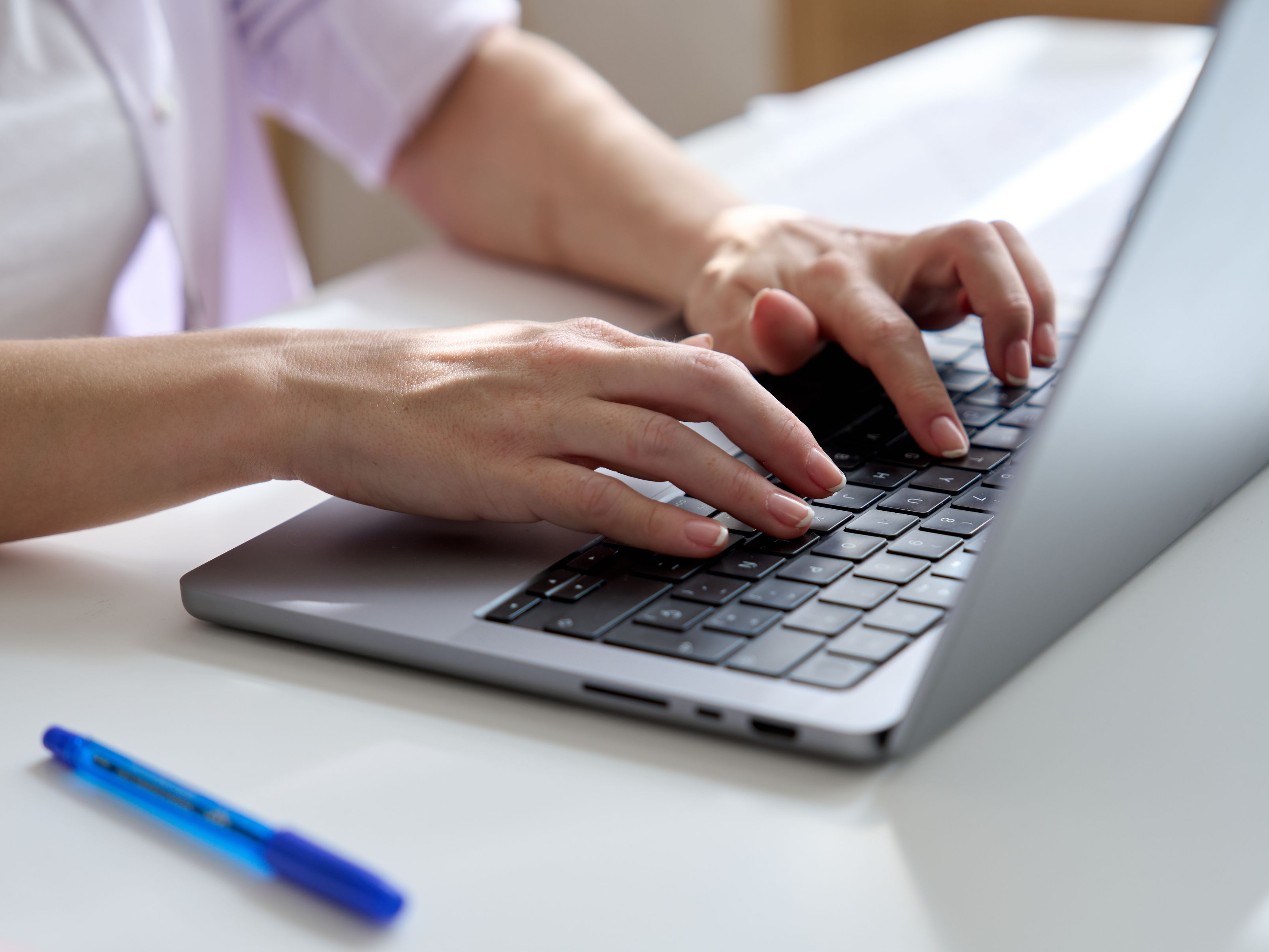 Close up of hands typing on laptop