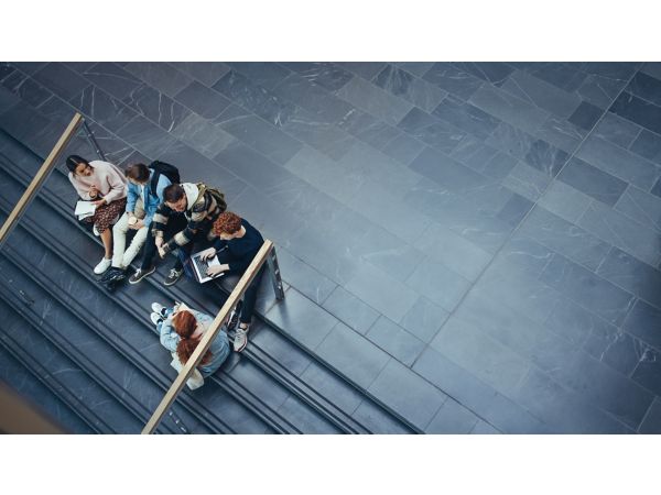 Students sitting and talking on a university staircase