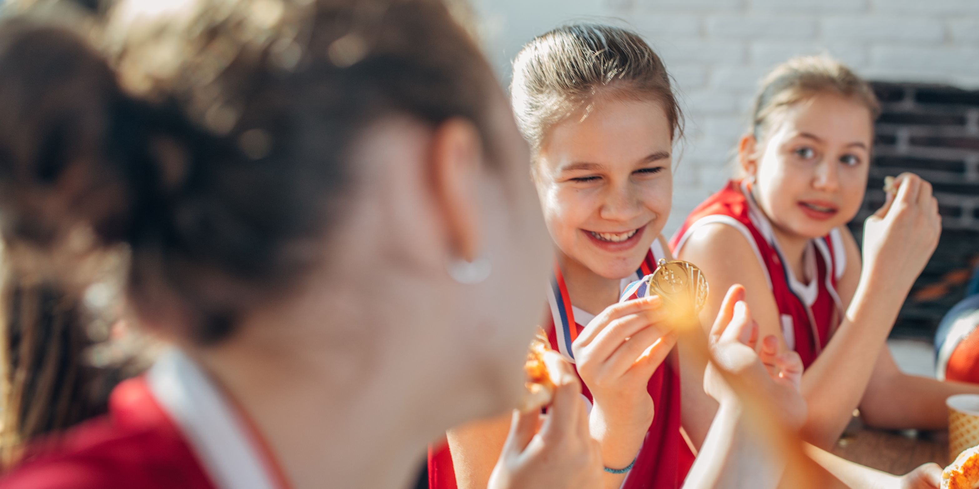 Young teammates eating together