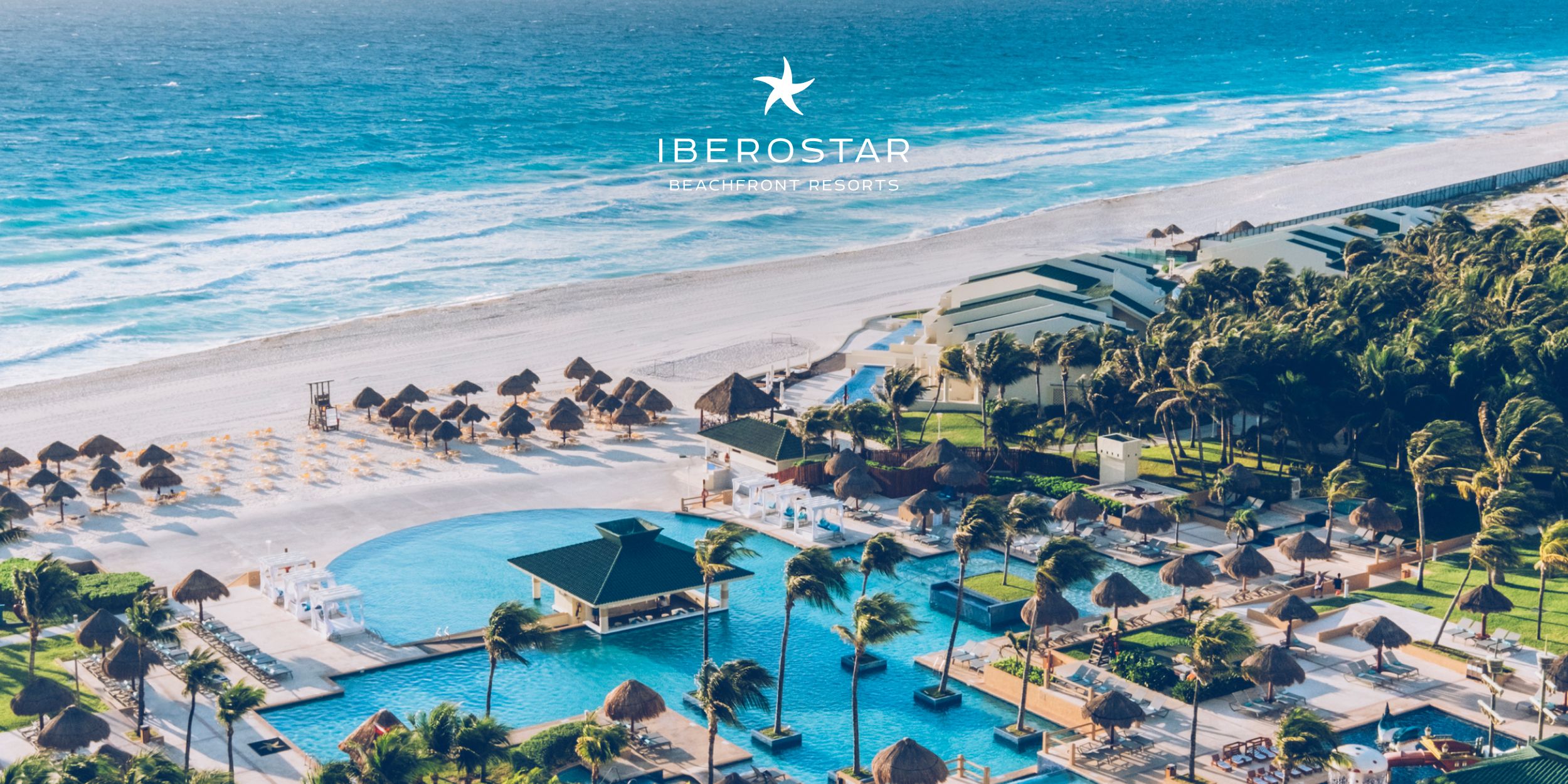 Mexico resort with pools, umbrellas and a white sand beach. 